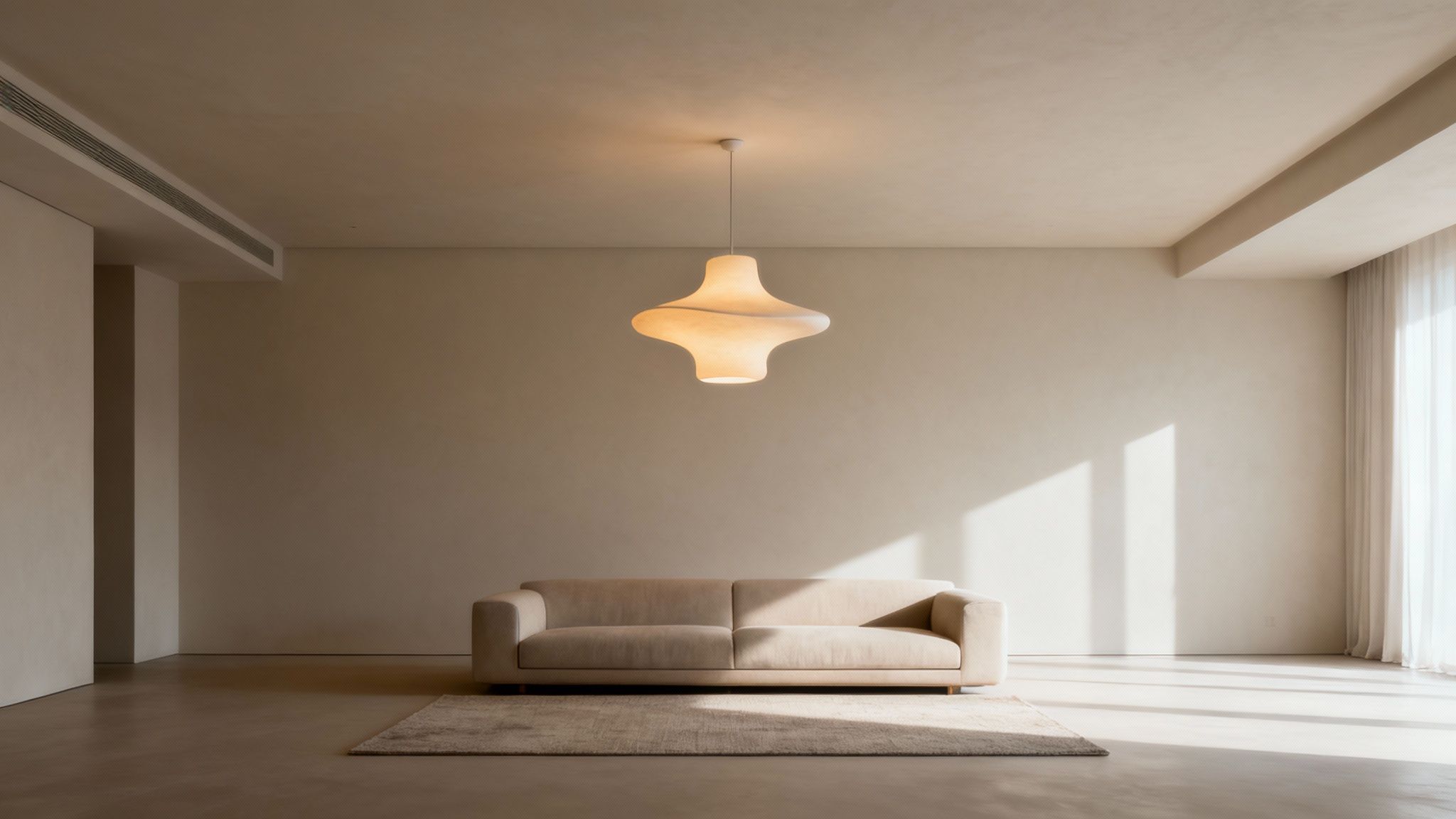 A contemporary living room with a unique, artistic ceiling light fixture casting a warm glow.