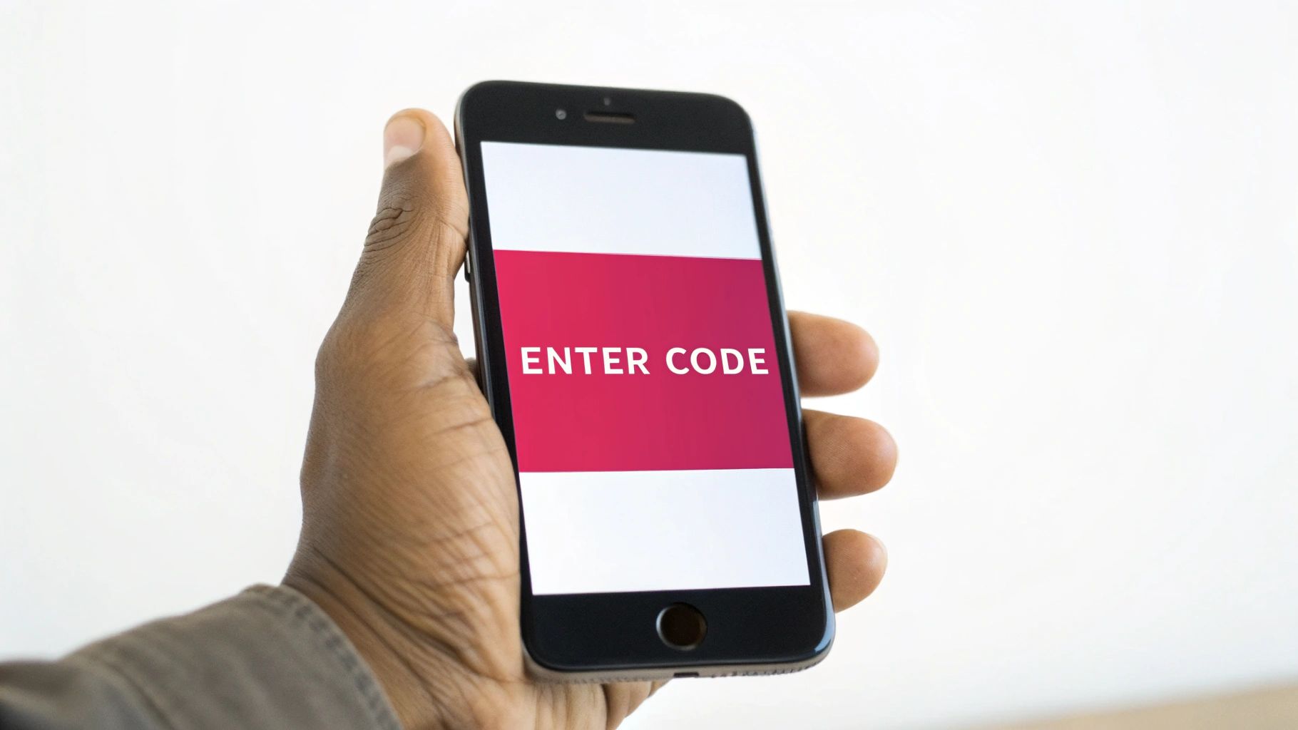 A dark-skinned hand holds a black smartphone displaying "ENTER CODE" on its bright red screen.