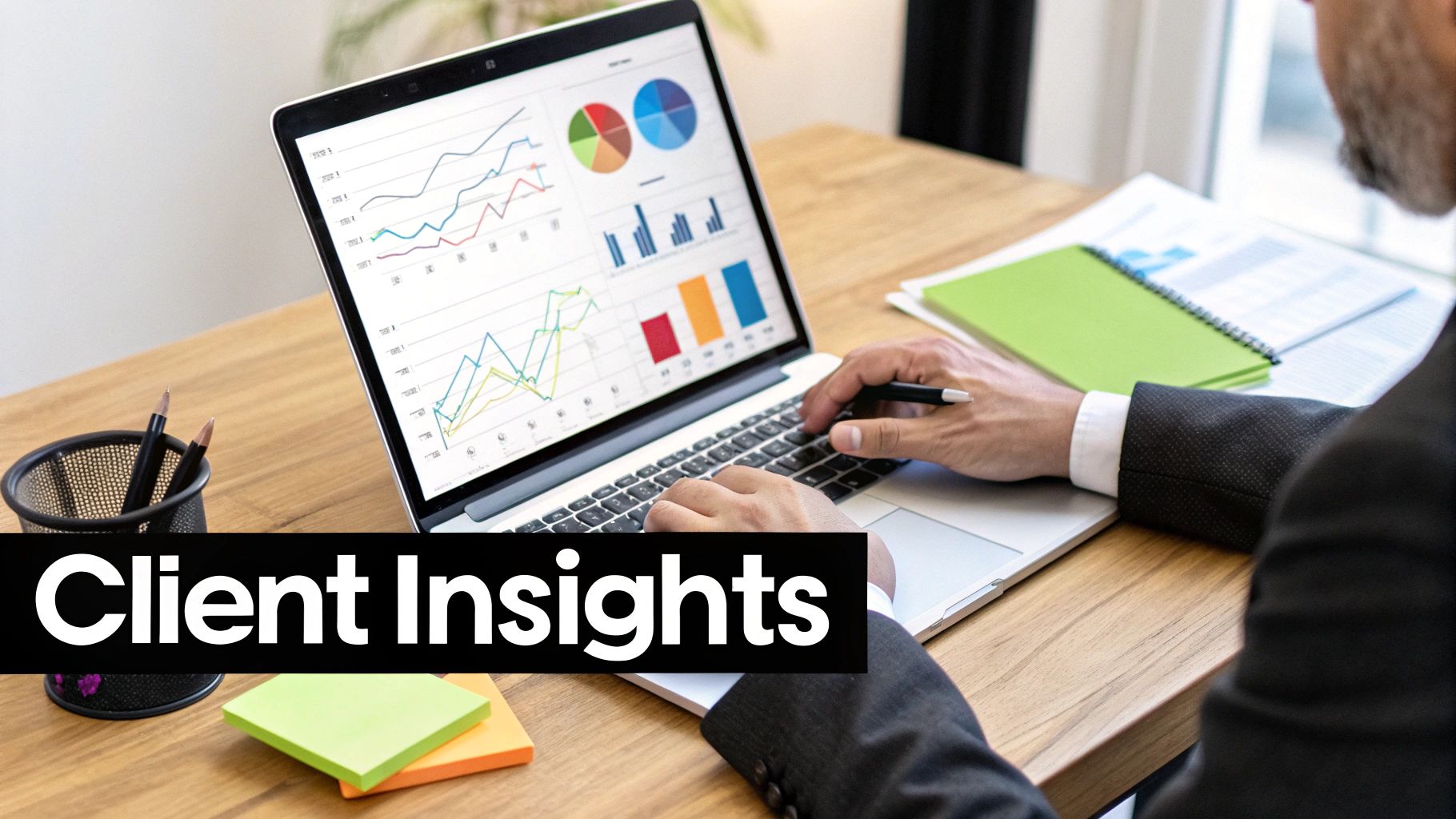 A person at a desk meticulously planning out a proposal with notes and a laptop.