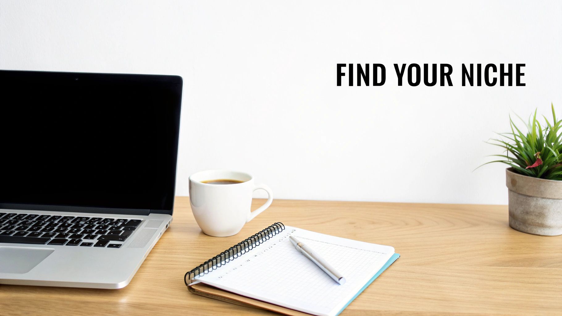 A person sitting at a desk with a laptop, notebooks, and a cup of coffee, planning their freelance business foundation.