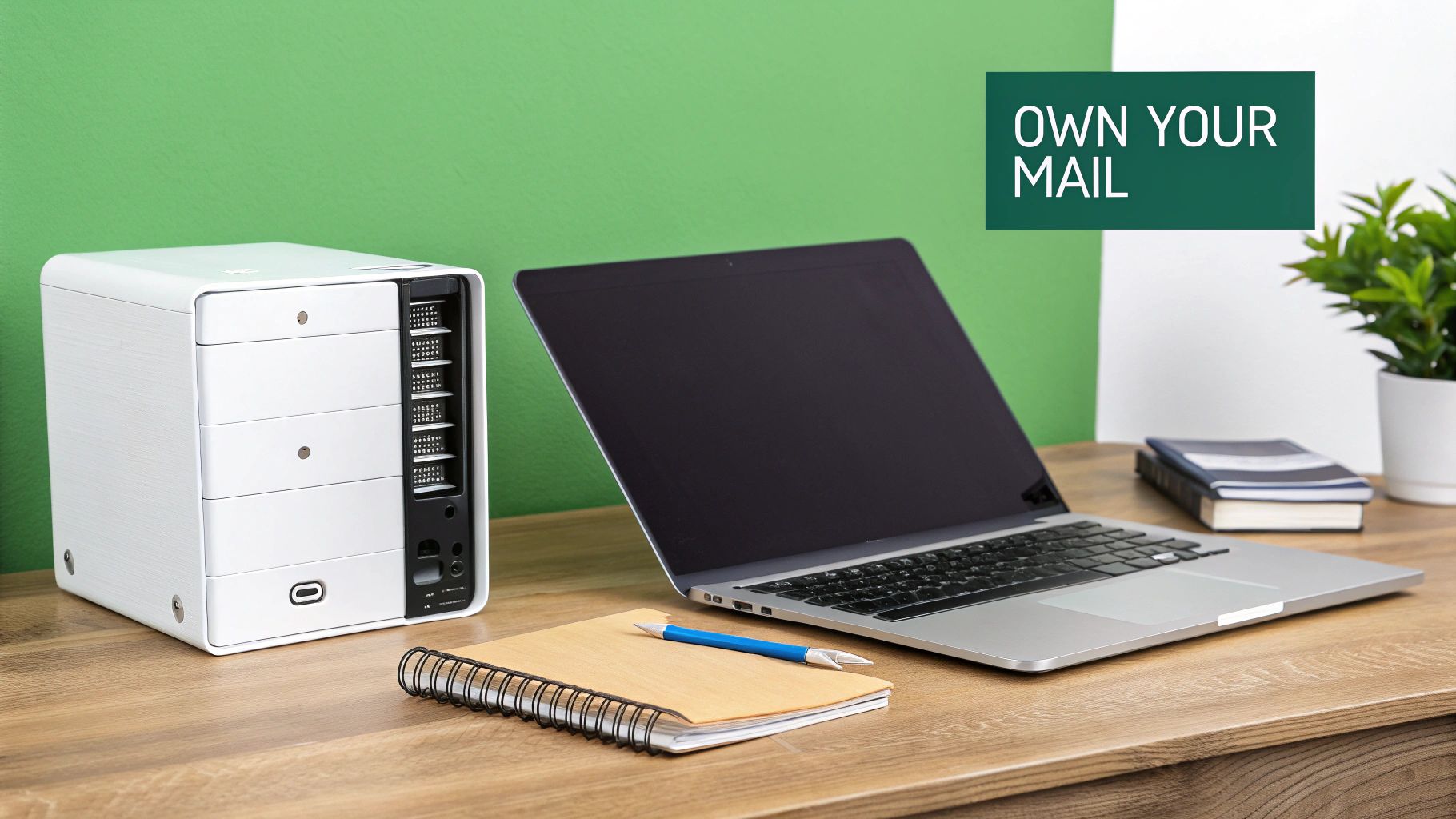 White mail server unit next to laptop computer on wooden desk in modern office
