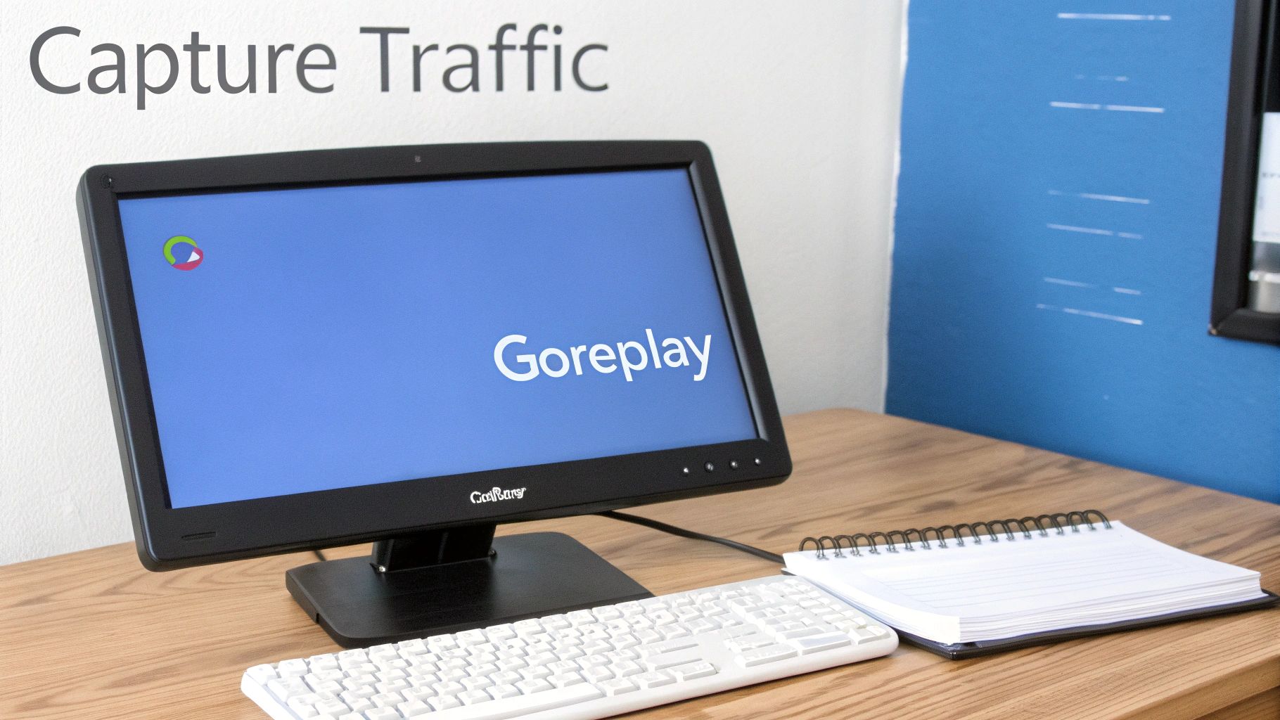 A computer monitor displaying 'Goreplay' software, a white keyboard, and a notebook on a wooden desk.