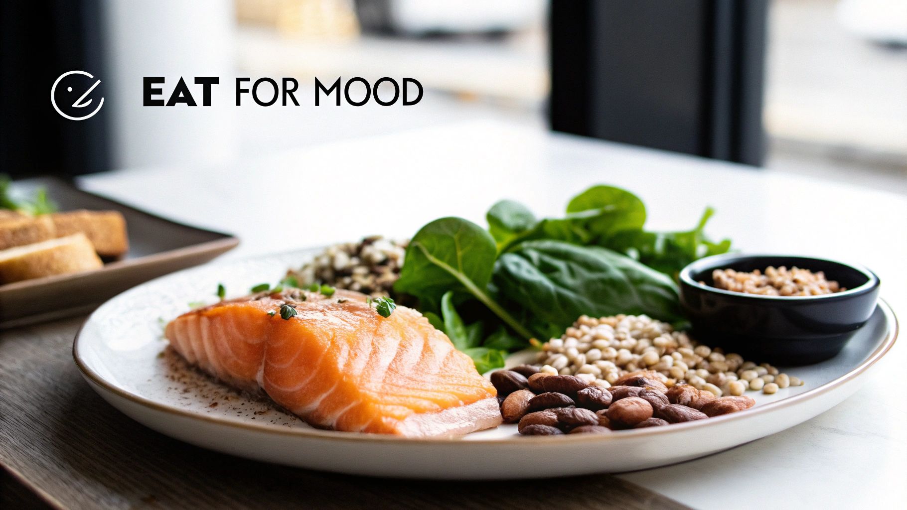 Close-up of a healthy meal with salmon, spinach, various grains, and nuts on a white plate, highlighting 'Eat for Mood'.