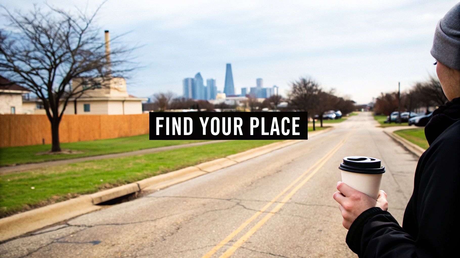 Person holding coffee cup looking at Dallas skyline from residential neighborhood street