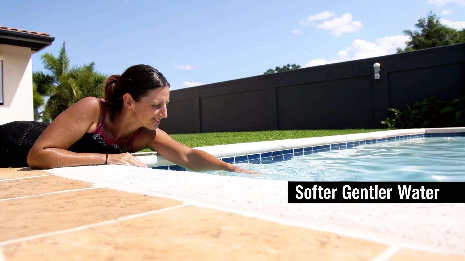 A pristine, modern saltwater pool in a backyard with comfortable lounge chairs.