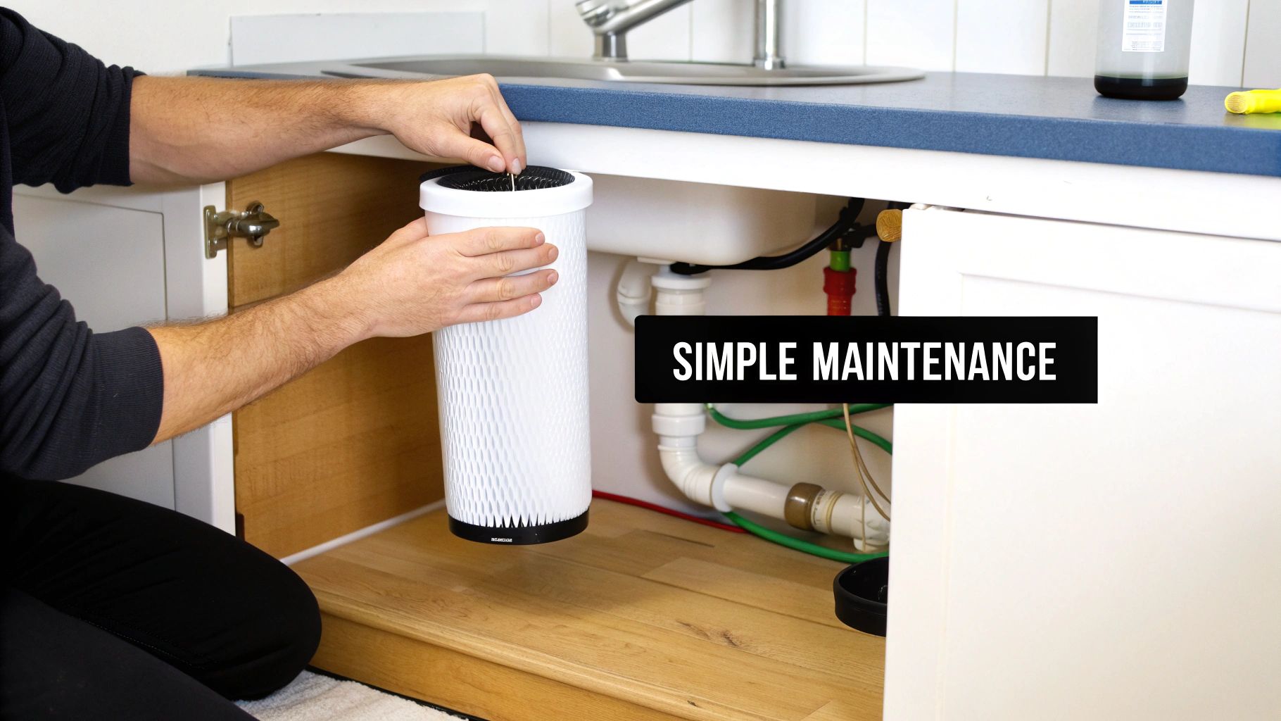 A person's hands installing a white water filter under a kitchen sink, emphasizing simple maintenance.