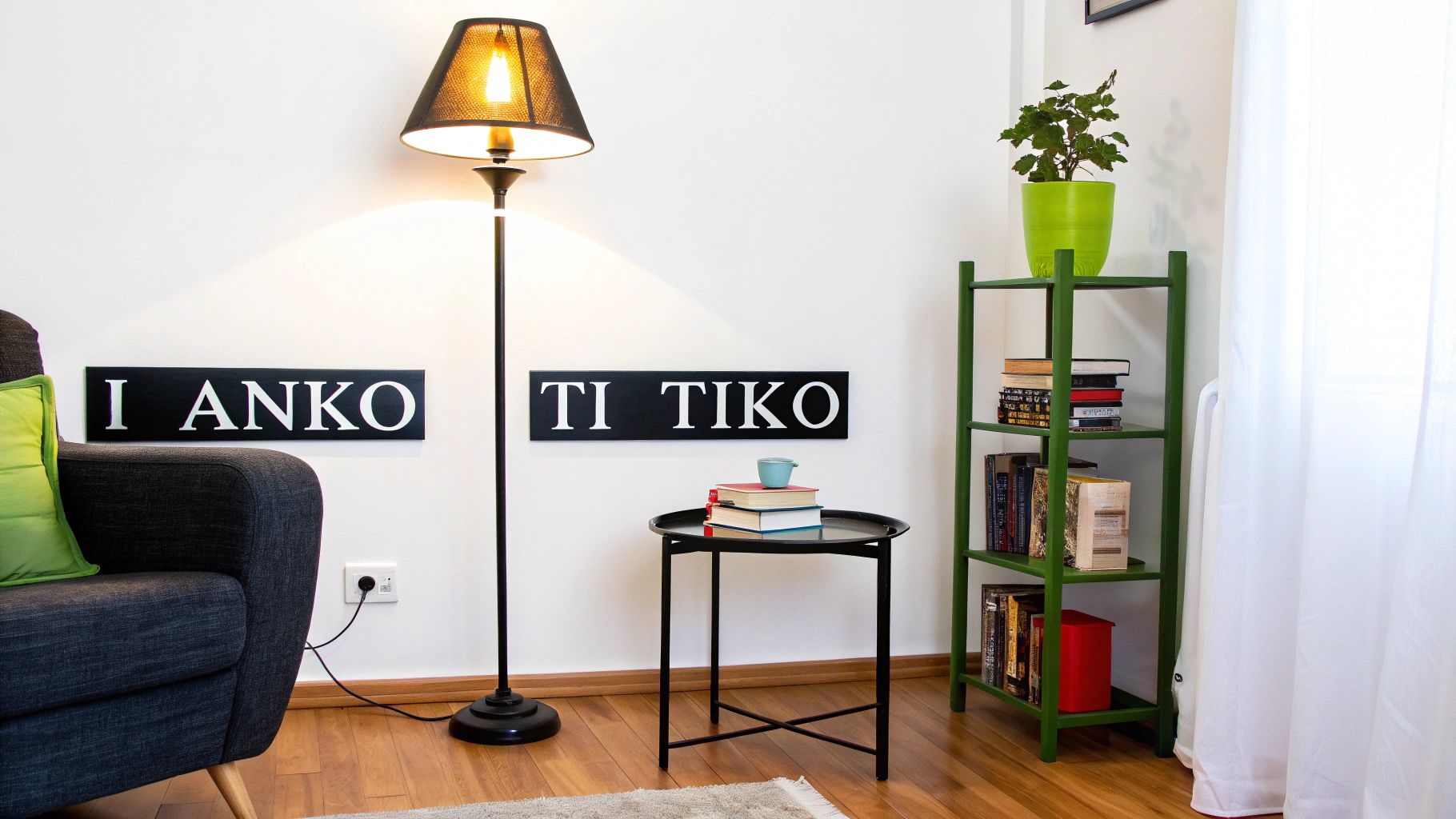 Γωνία σαλονιού με σκούρο γκρι καναπέ, φωτιστικό δαπέδου, πράσινη βιβλιοθήκη με φυτό και δύο διακοσμητικούς πίνακες.