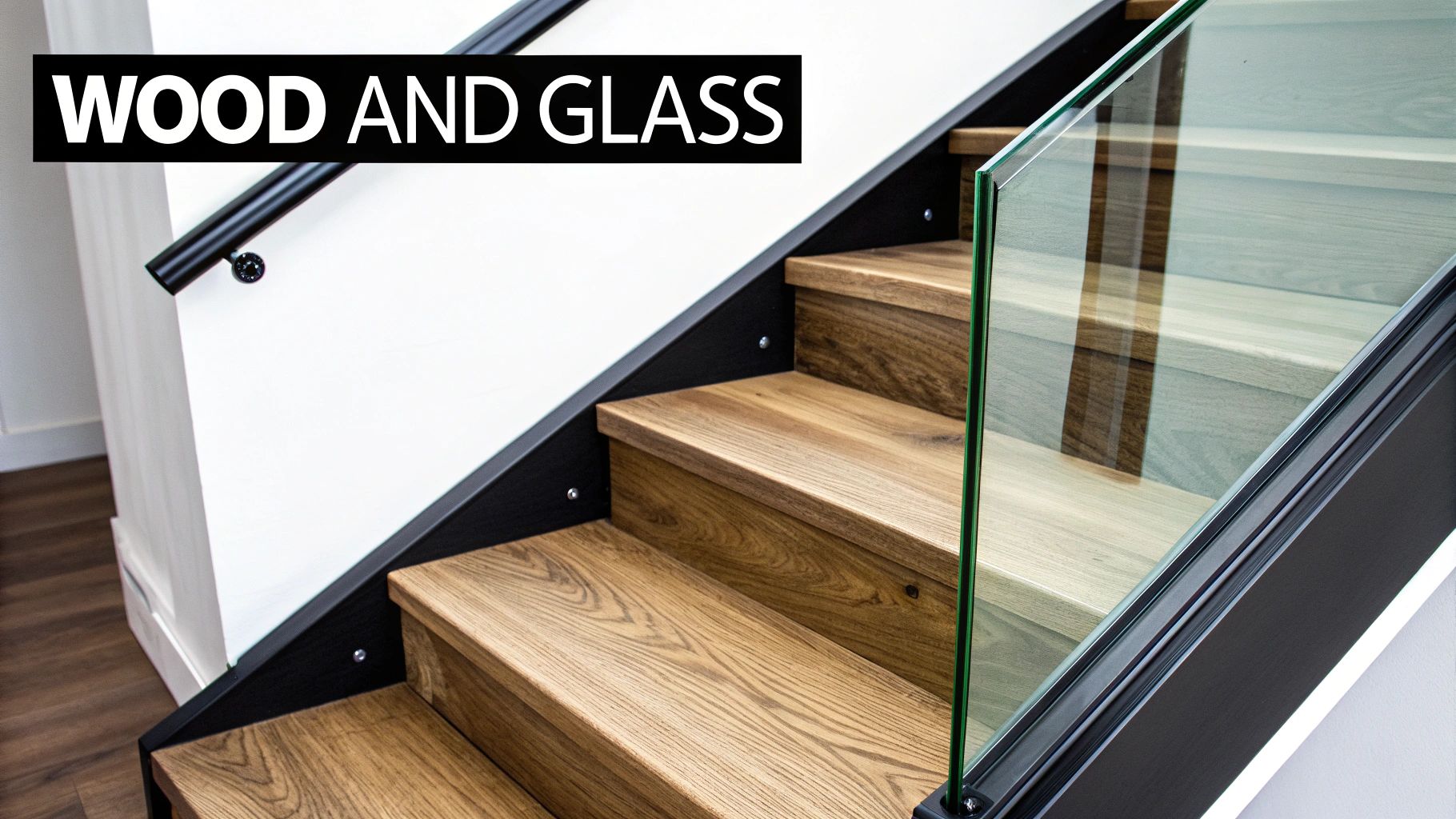 A modern staircase featuring rich wooden steps, a sleek glass railing, and a black handrail for a contemporary home.