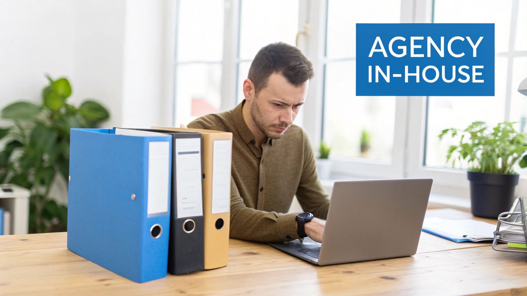 Marketing Agency Vs In House Team desk-based comparison Marketing Agency Vs In House Team comparison showing a professional working at a desk reviewing agency and in-house marketing options