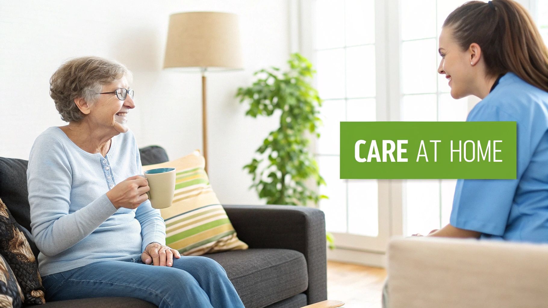A smiling elderly woman shares a cup of tea with her caregiver in a cozy home setting.
