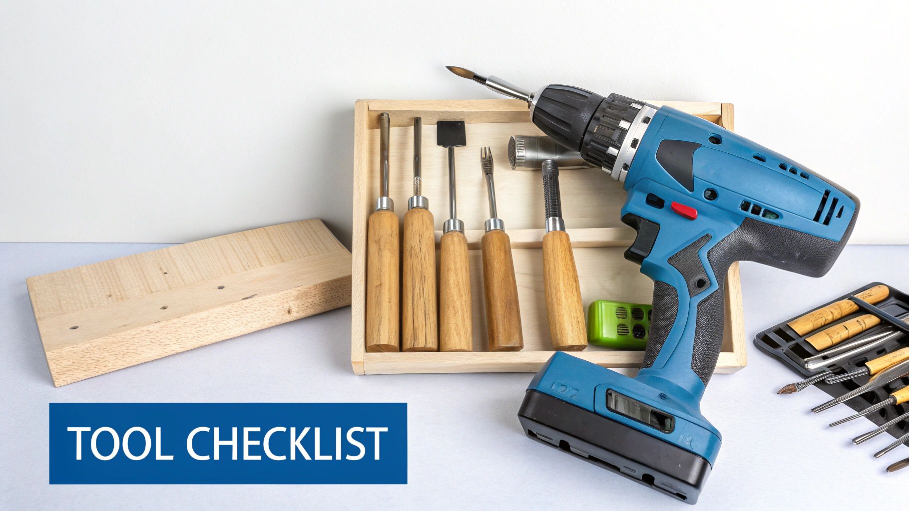 A collection of woodworking tools including chisels, a mallet, and a drill laid out on a workbench.