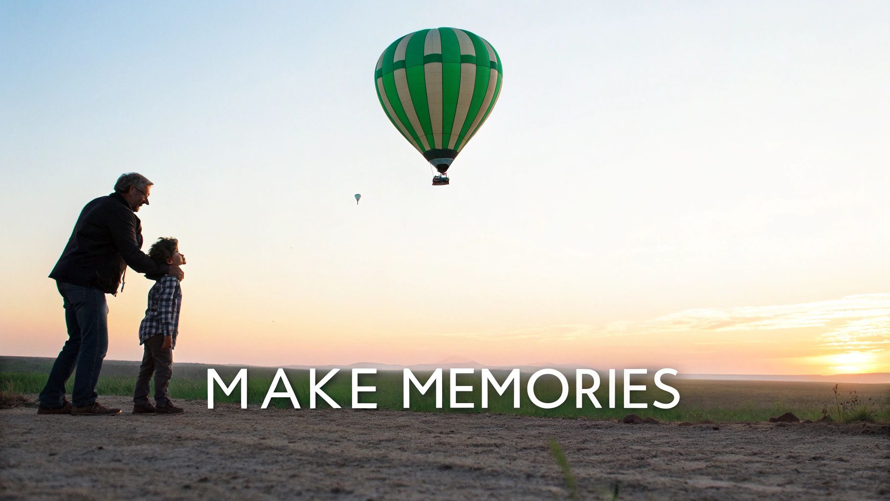 Father and child watching hot air balloons float at sunset creating special memories together