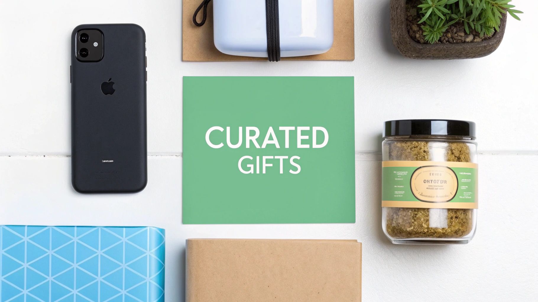A flat lay of various curated gift items on a white background, including an iPhone and a jar.
