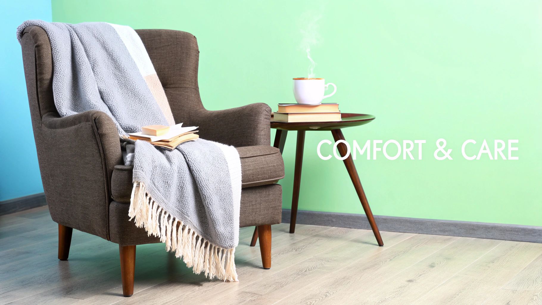 Cozy brown armchair with a knitted blue and white blanket, books, and a steaming mug on a side table, against a light green and blue wall.