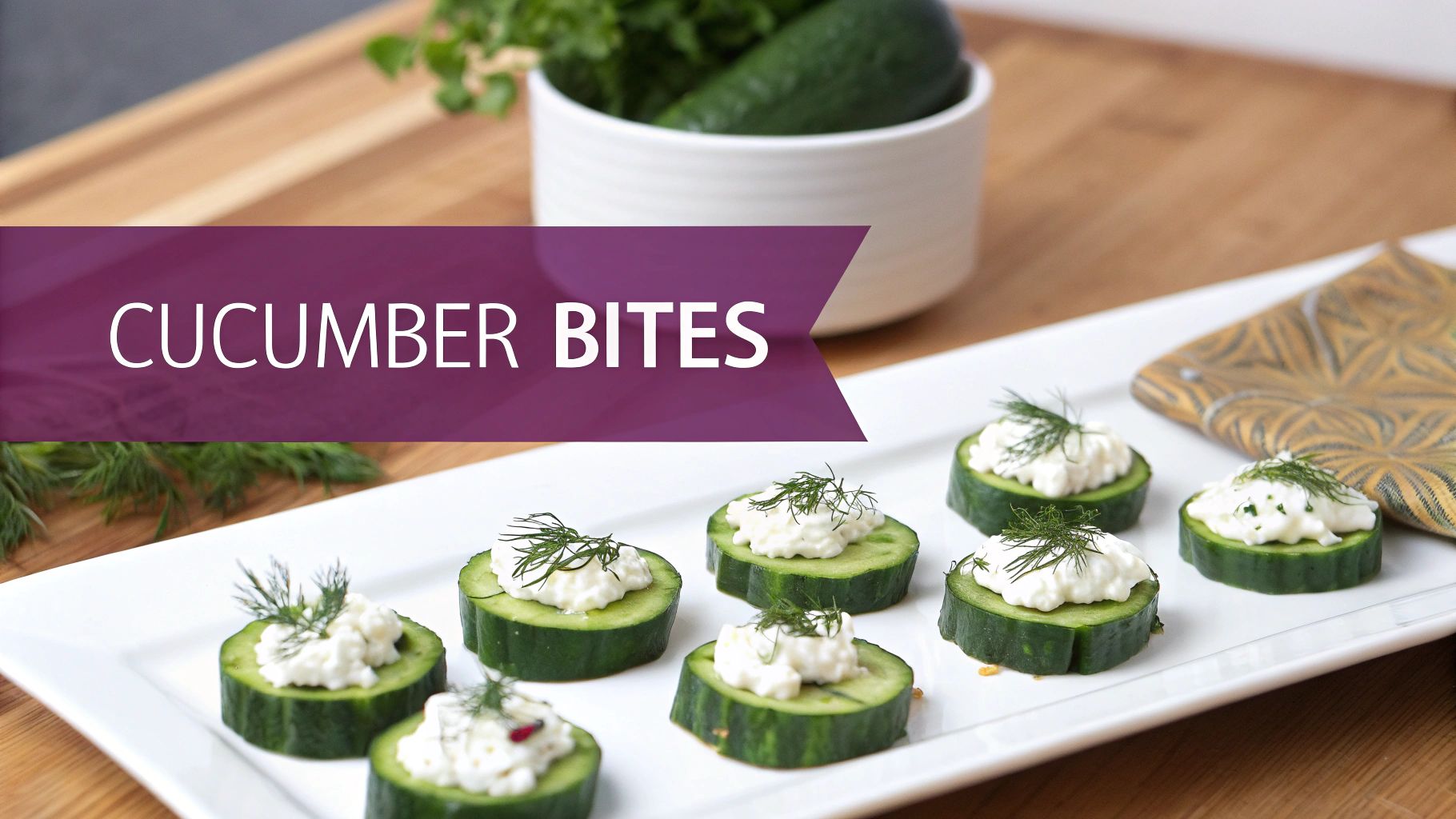 Delicious cucumber bites topped with creamy cheese and fresh dill on a white platter.