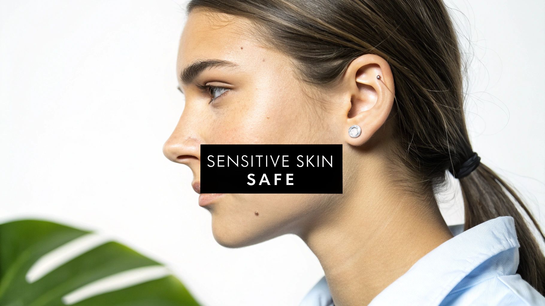 A person with a sensitive expression touching their earlobe, indicating potential irritation from a piercing.