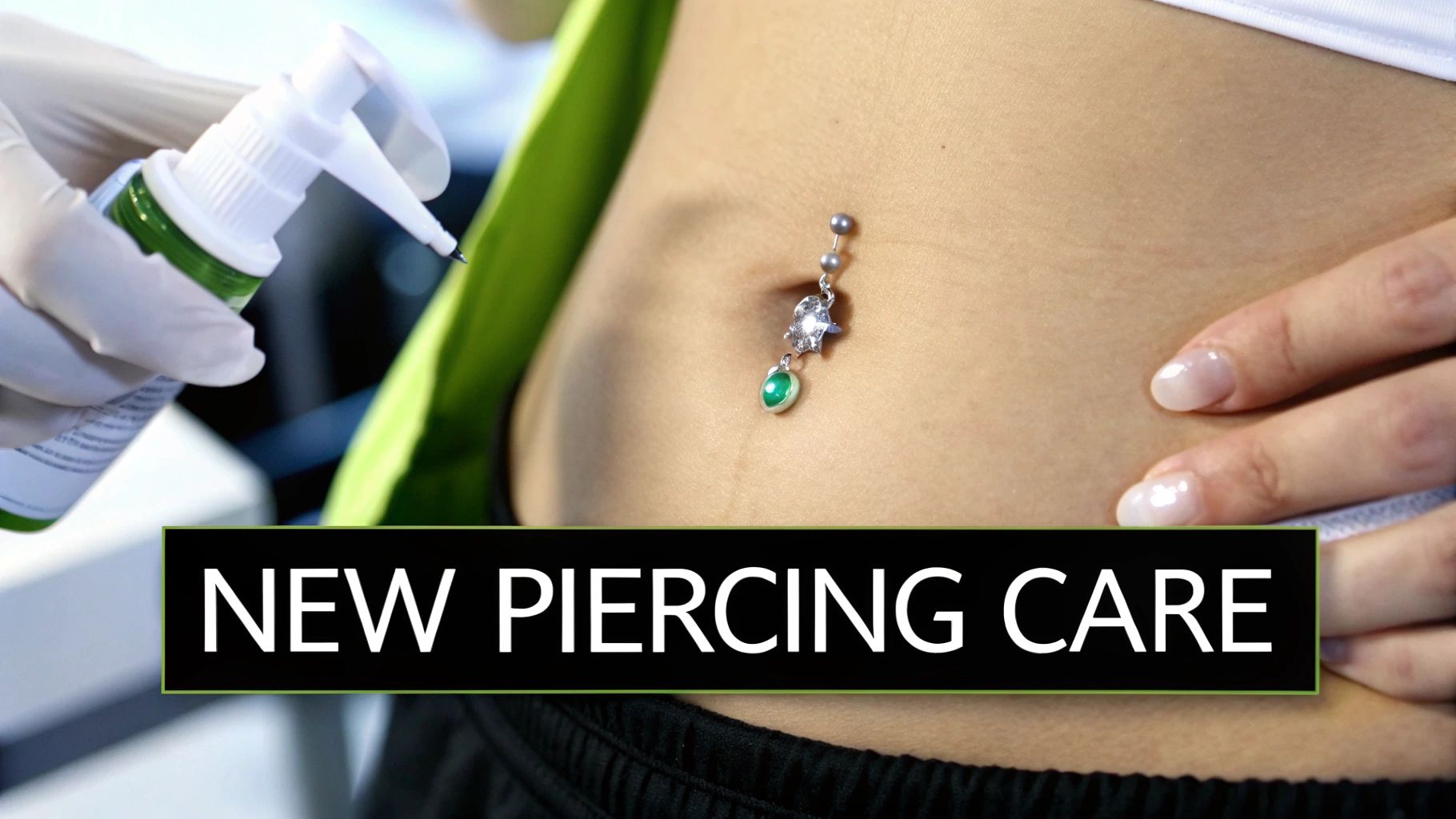 A person showing off their healed navel piercing with a stylish belly ring.