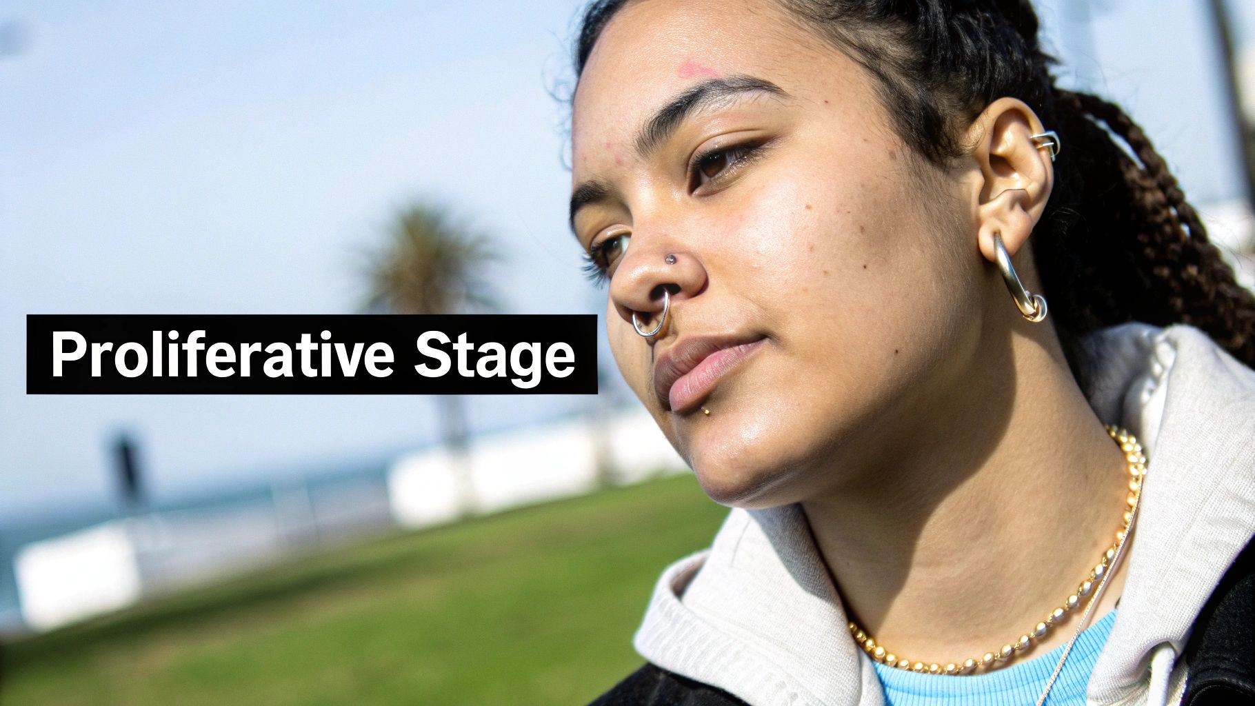 A person showing their healed septum piercing with a stylish ring.
