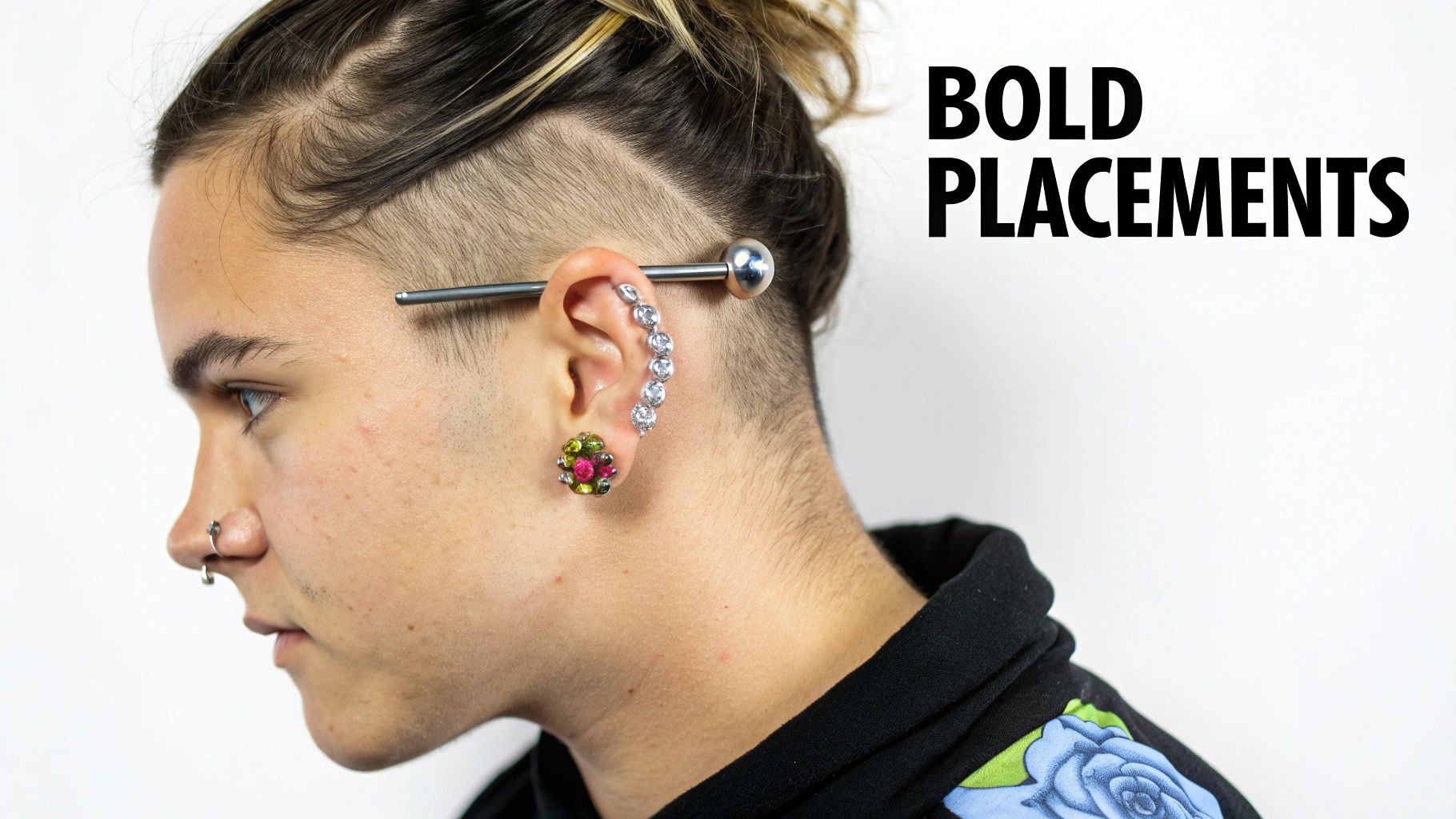 Person displaying industrial bar piercing with jeweled ear cuff and colorful lobe earring