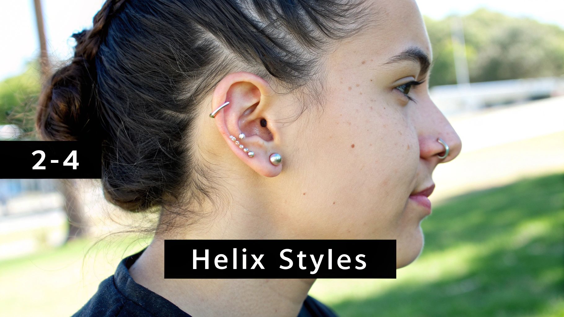 Woman showcasing multiple helix piercings with silver jewelry studs and curved barbell