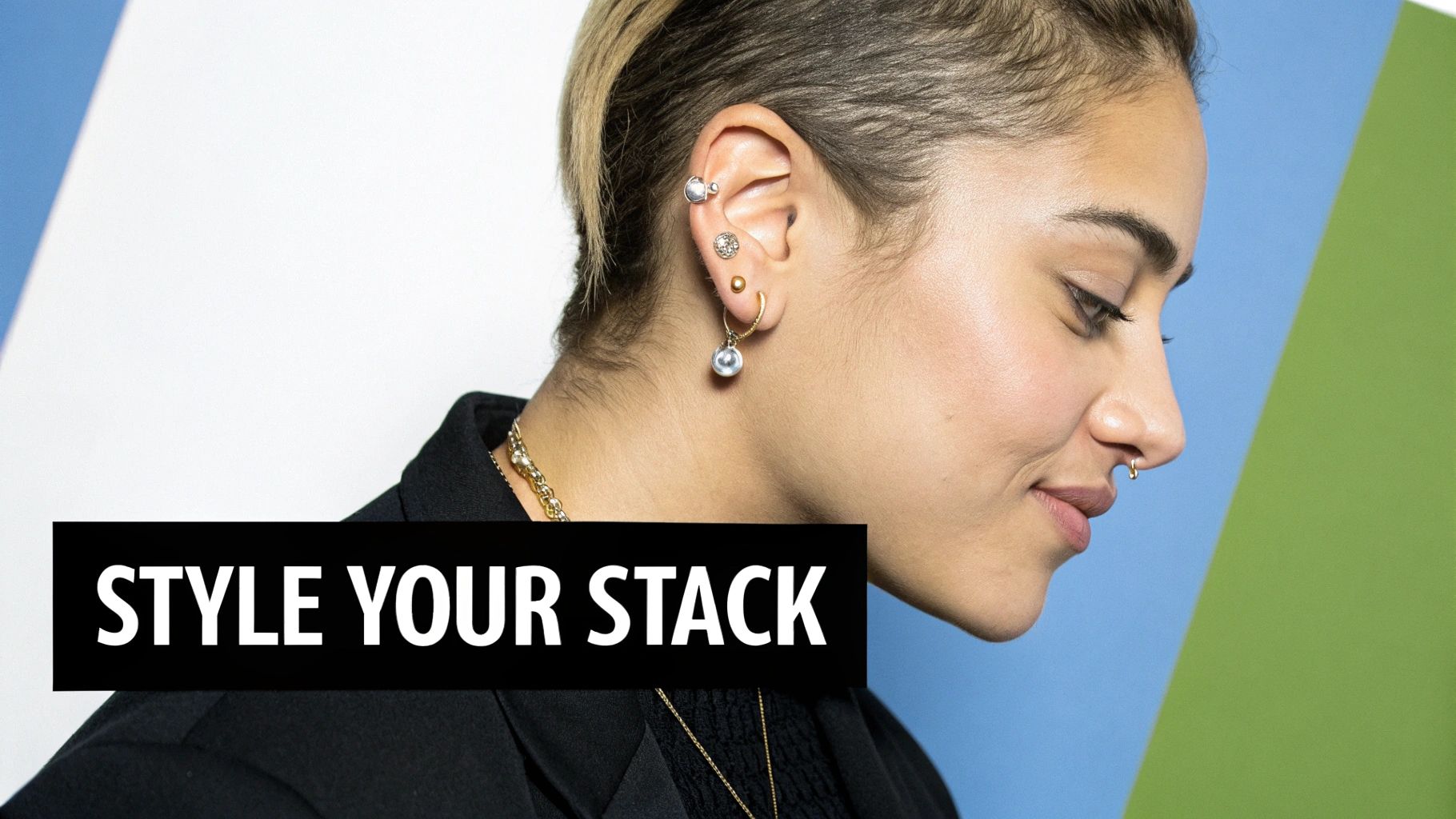 Side profile of a person showcasing multiple stylish ear piercings and a small nose ring.