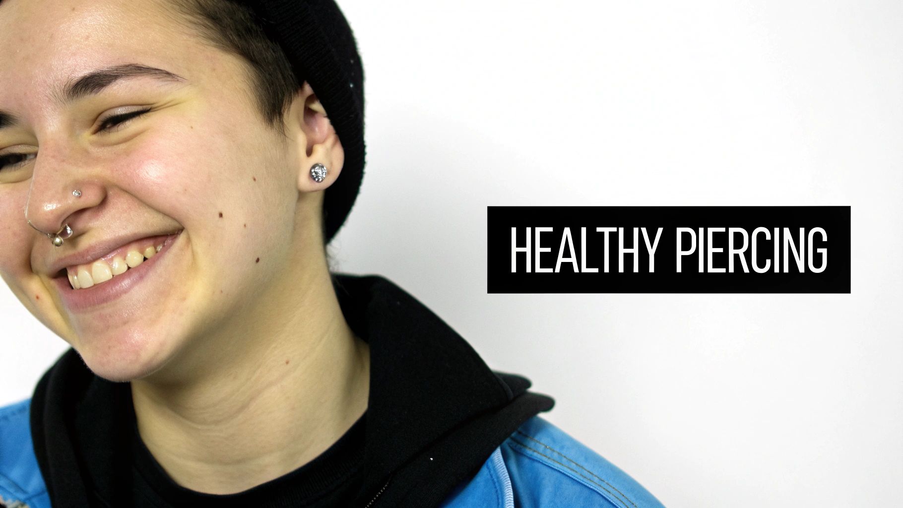 A smiling person with multiple nose and ear piercings, next to a black box with text 'HEALTHY PIERCING'.