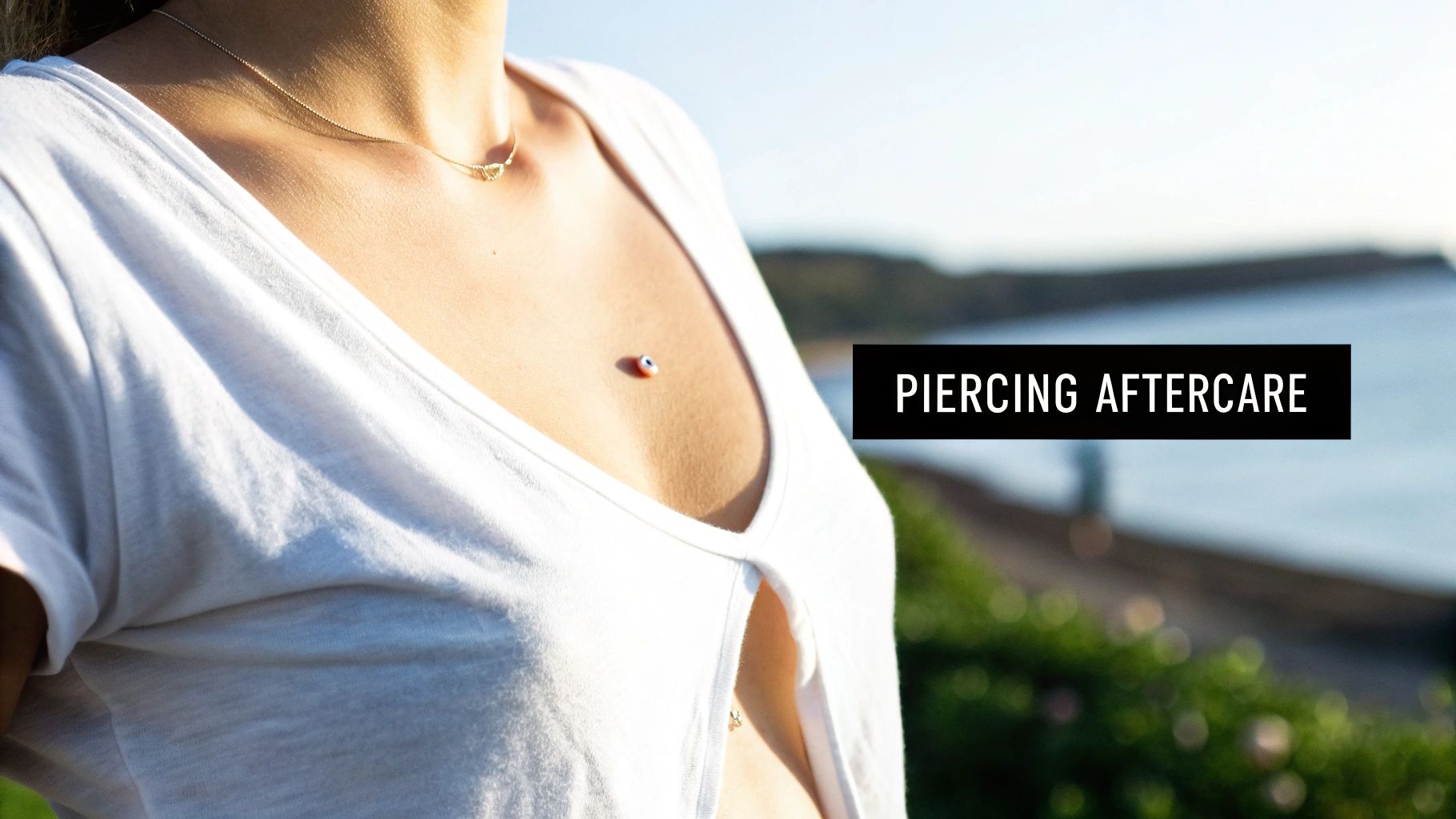 Close-up of a person's chest with healed nipple piercings and stylish jewelry.