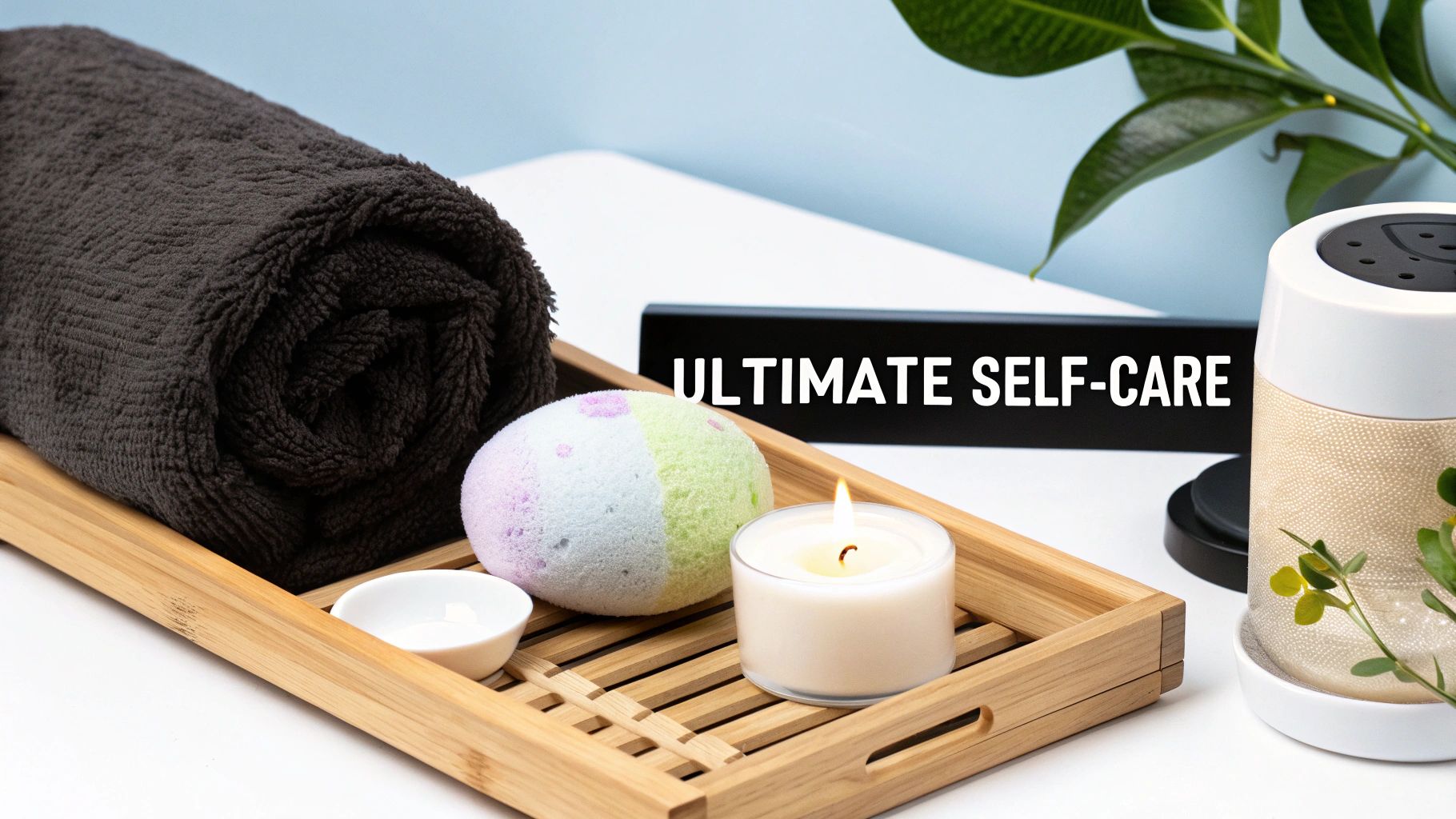 A beautifully arranged self-care gift set featuring a candle, bath bomb, and a plush towel.
