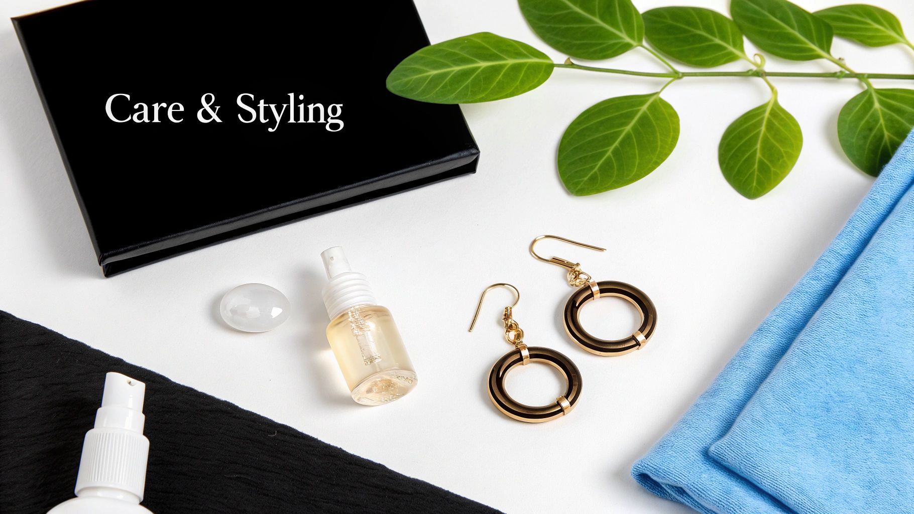 Care and styling essentials including gold earrings, spray bottles, and cloths on a white surface.
