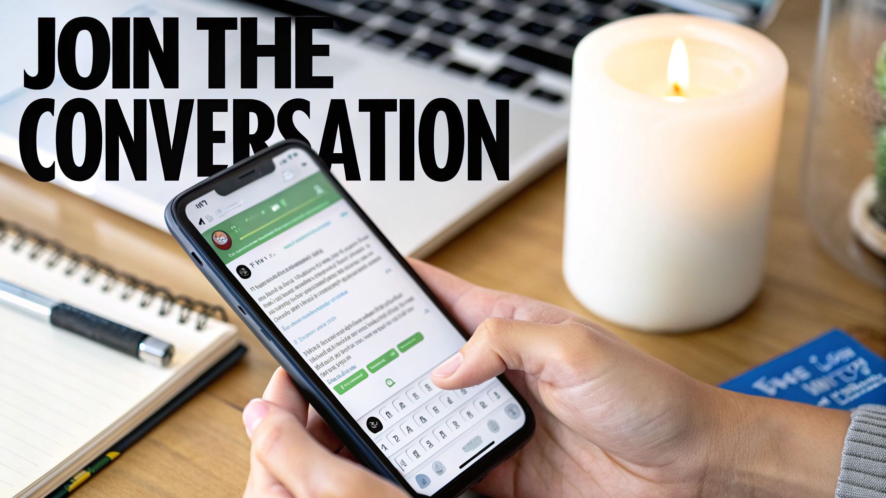 Hands typing on a smartphone, joining an online conversation, with a laptop and candle.
