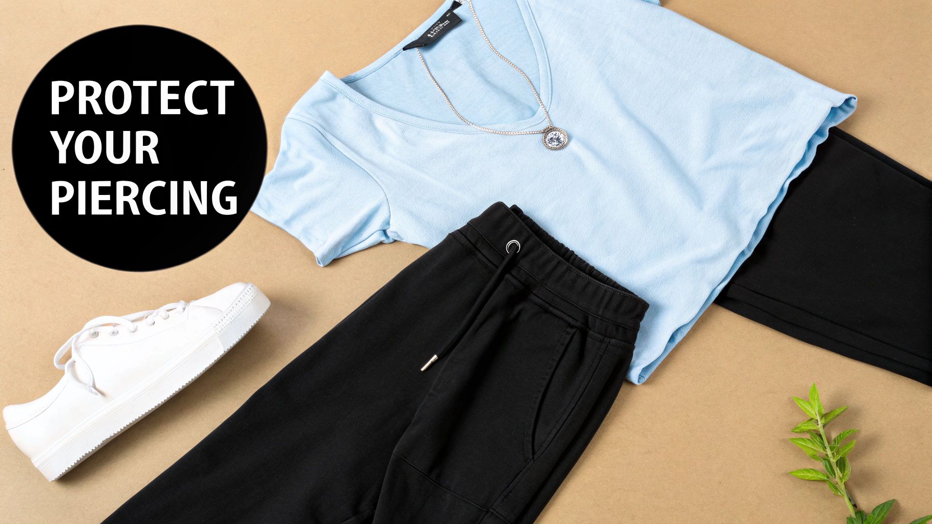 Flat lay of light blue t-shirt, black pants, white sneakers, necklace, and 'PROTECT YOUR PIERCING' text.