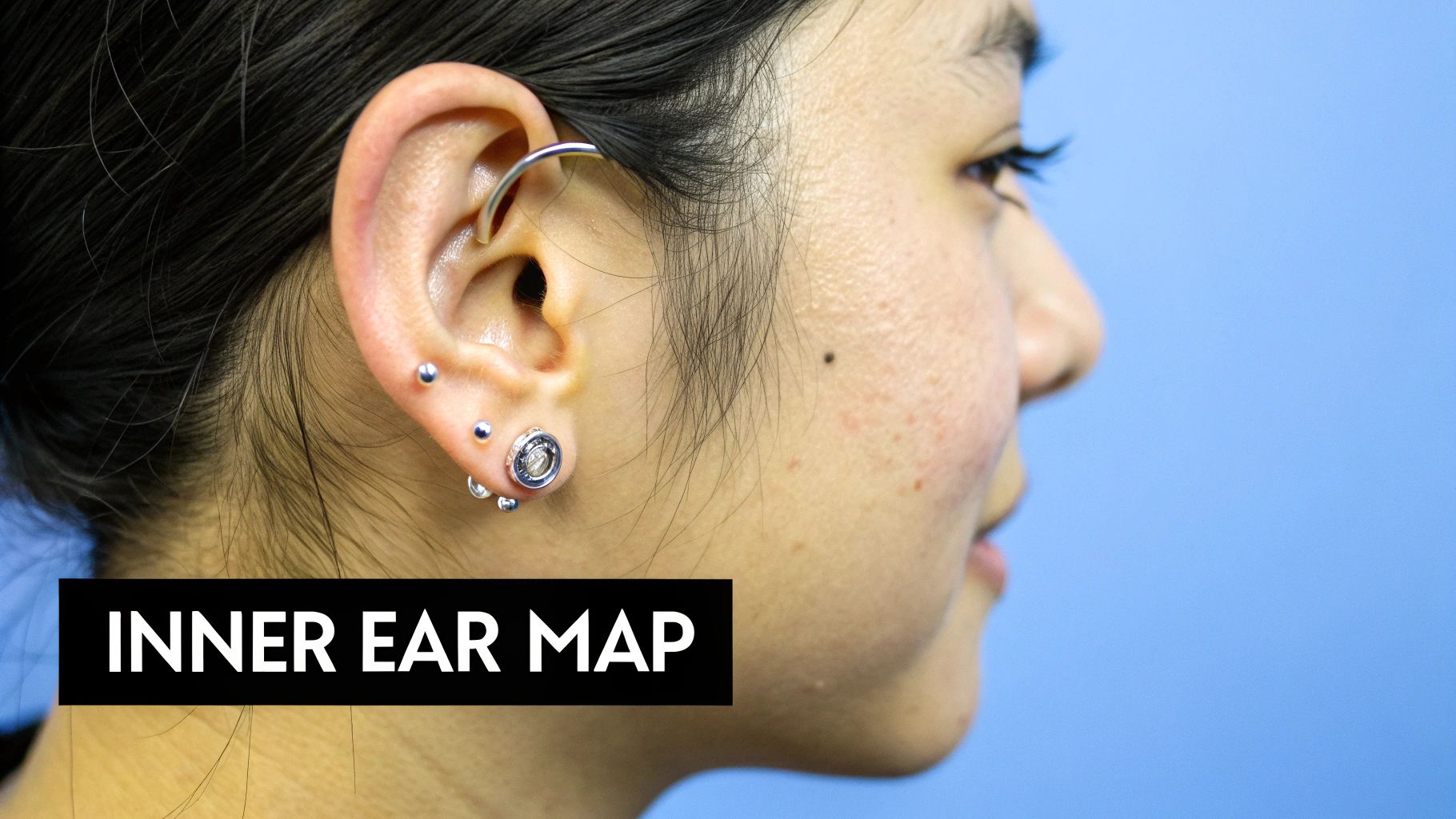 Side profile showing multiple ear piercings including cartilage helix and lobe studs on woman