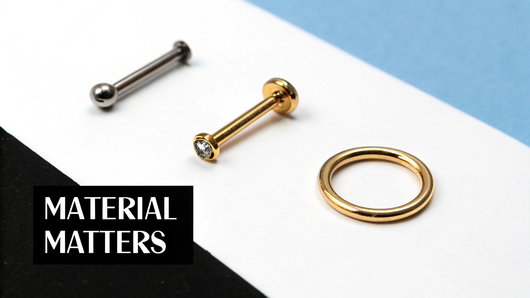 Various gold and silver body piercing jewelry pieces, including a labret stud, barbell, and seamless ring, highlighting material quality.