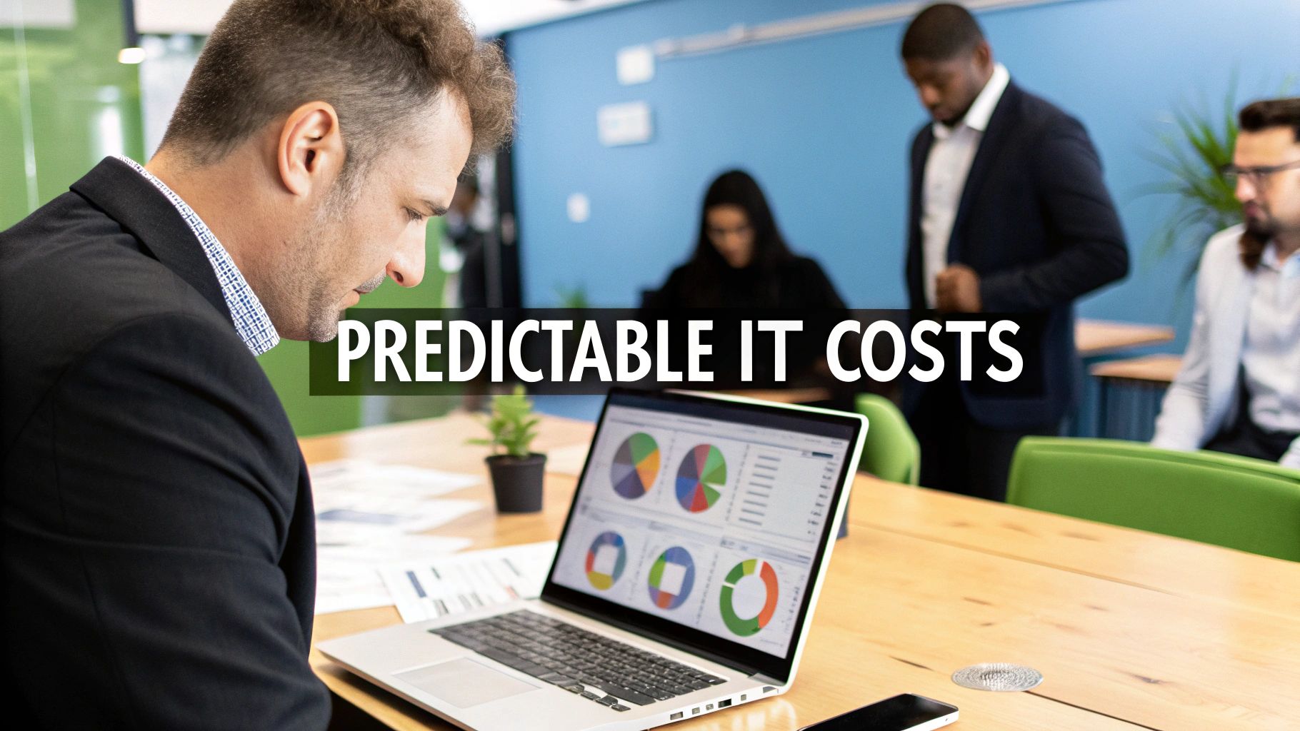 A man in an office reviews data charts on his laptop, with text 'PREDICTABLE IT COSTS'.