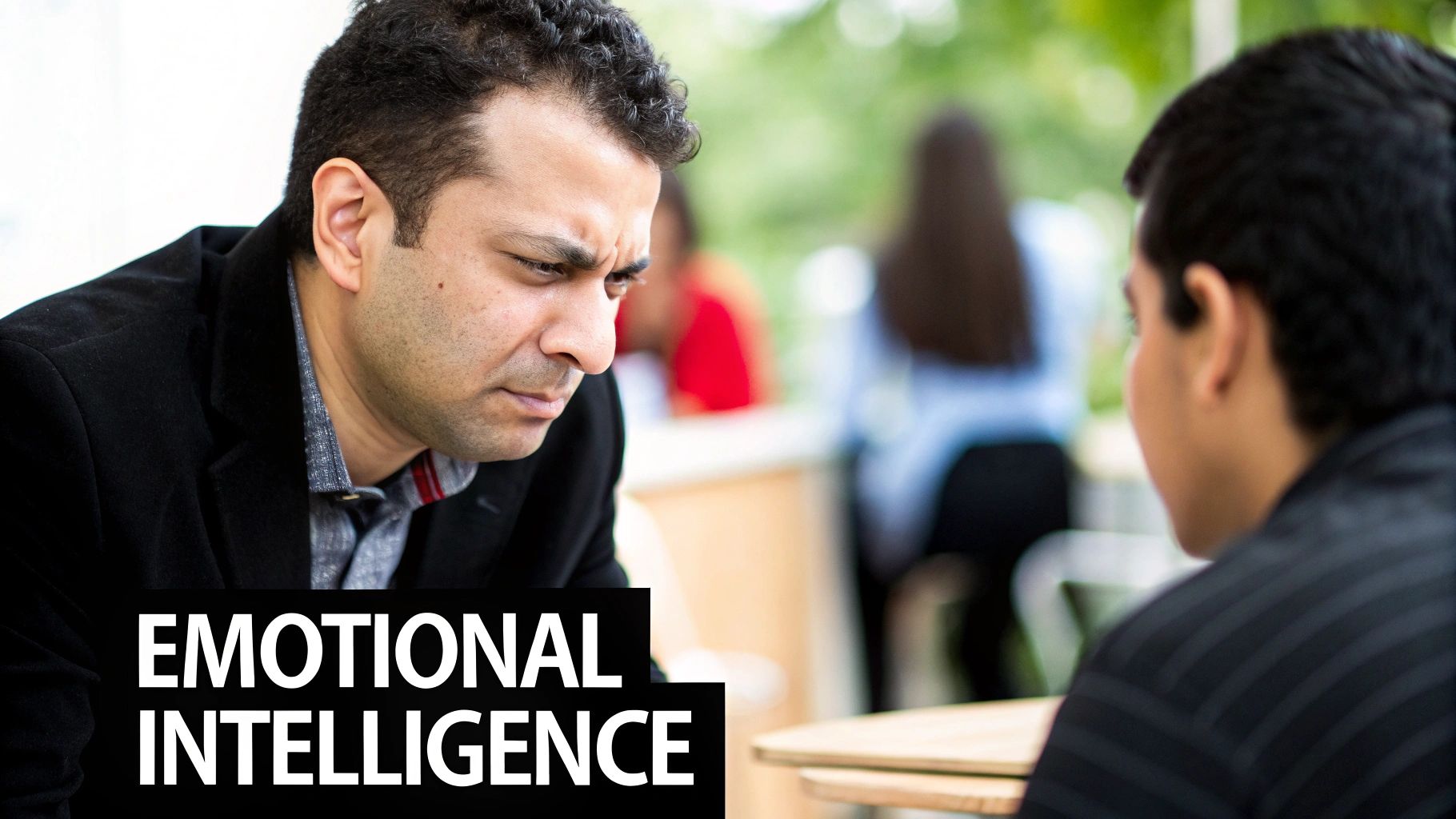 A man listens intently during a serious discussion, with 'EMOTIONAL INTELLIGENCE' overlay.
