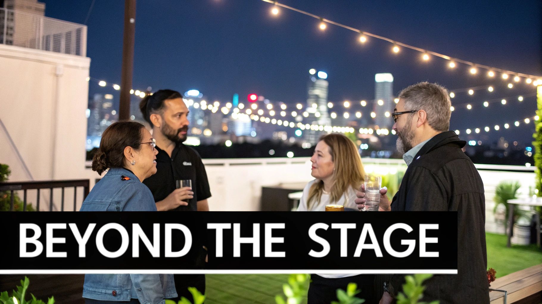 Four diverse individuals mingling on a city rooftop with string lights and urban skyline at night.