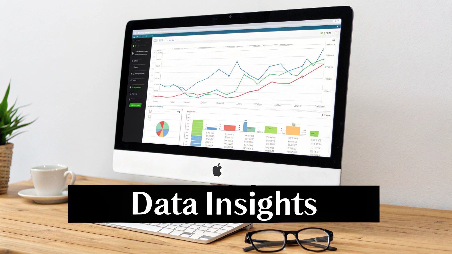 A computer monitor displays a data analytics dashboard with various graphs and charts on a wooden desk.