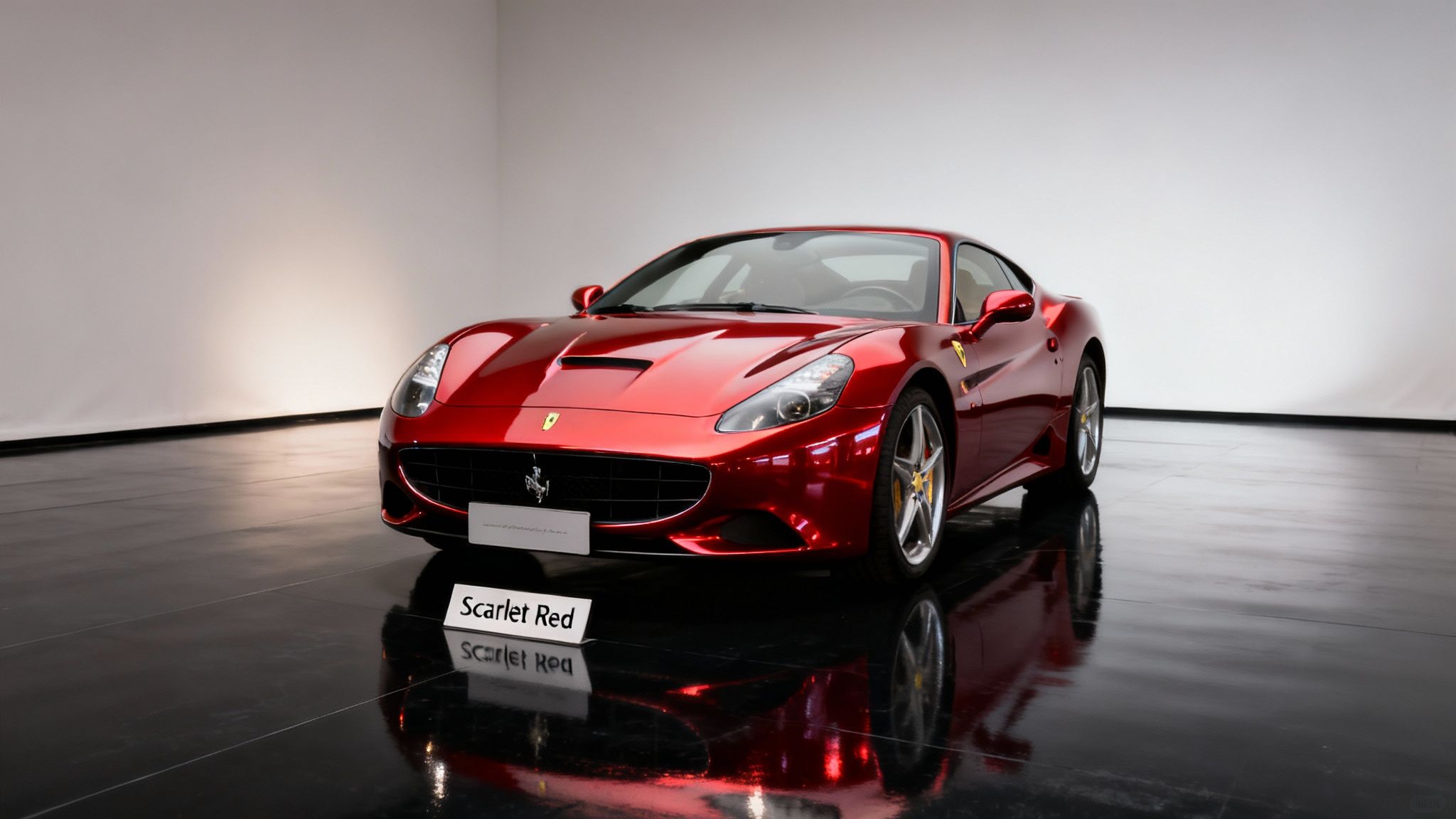 A gleaming scarlet red Ferrari sports car parked on a reflective black floor in a modern studio.