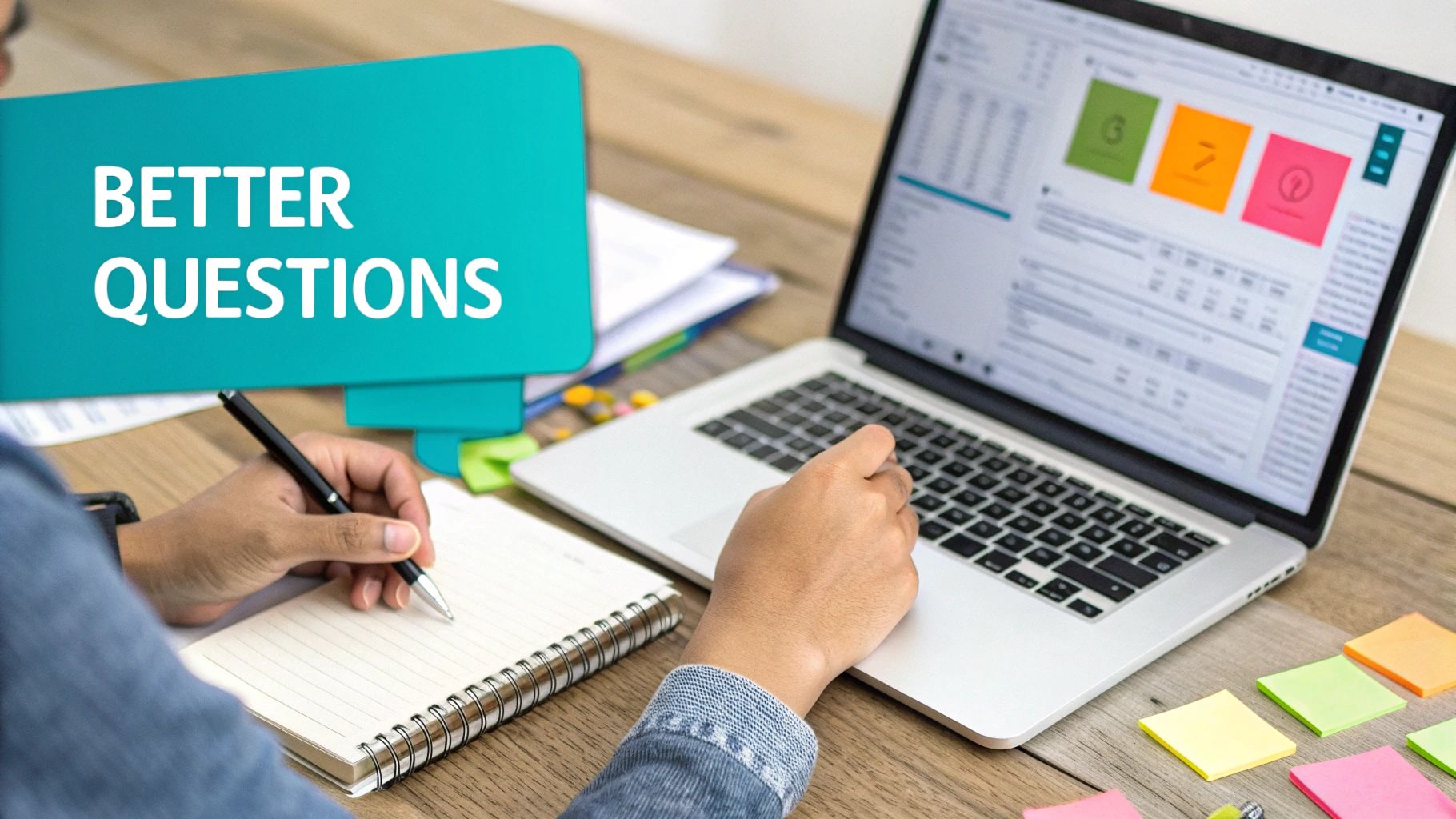 Person writing notes and typing on a laptop with a 'BETTER QUESTIONS' sign.