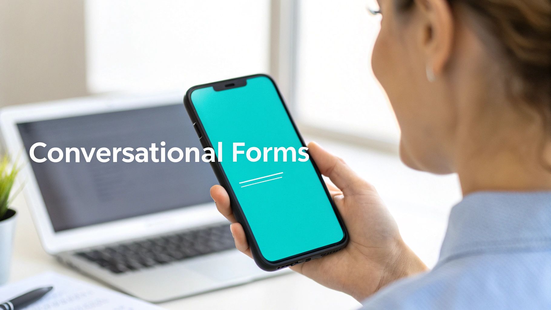A person holding a smartphone displaying a teal screen with 'Conversational Forms' text overlayed, near a laptop.