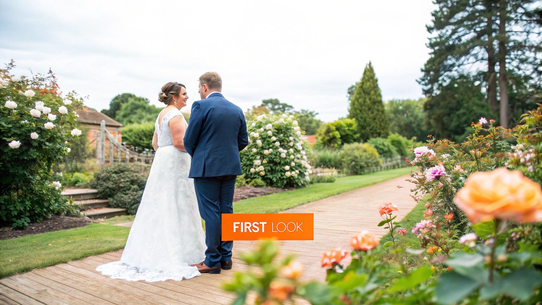 A bride taps her groom on the shoulder during an outdoor first look reveal, creating an intimate moment before their wedding ceremony.