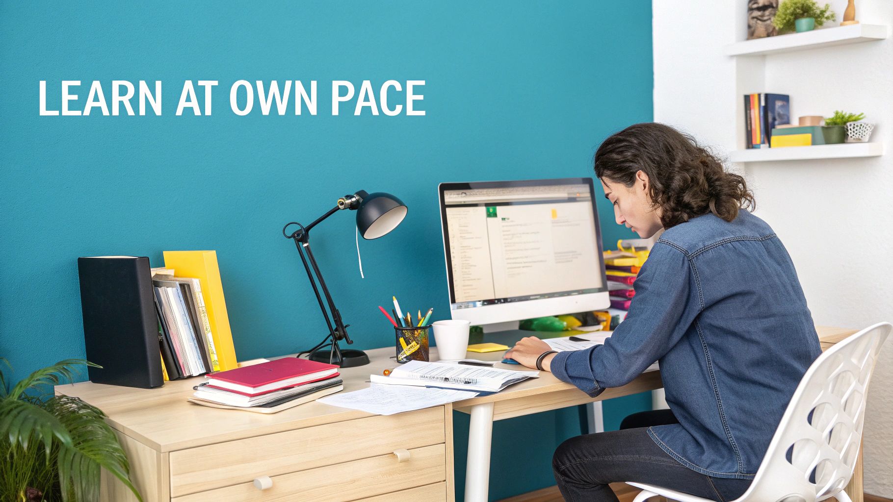 A bright, modern home office setup with a person studying on a laptop.