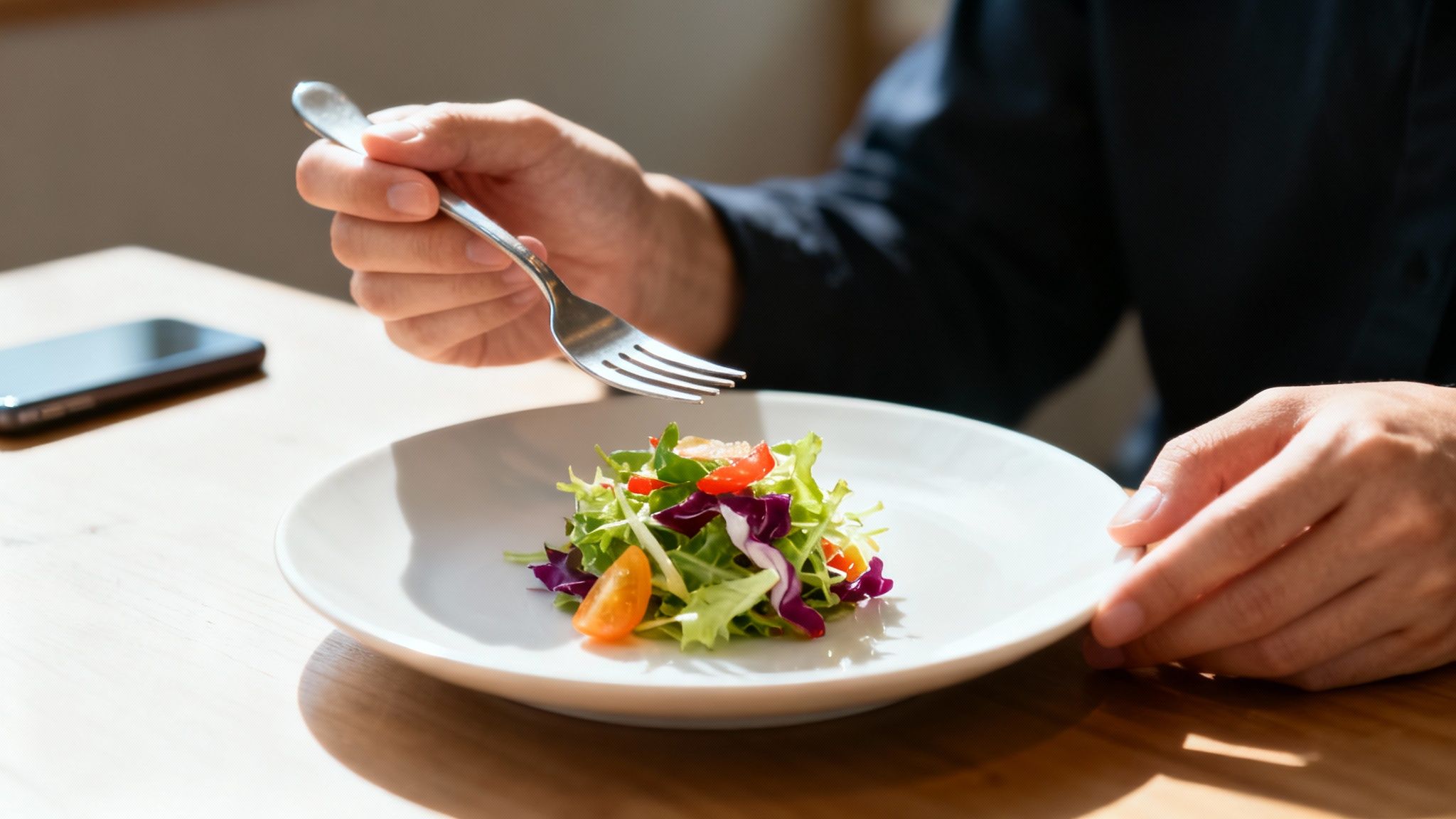 A person mindfully eating a healthy meal, focusing on the texture and taste of the food.