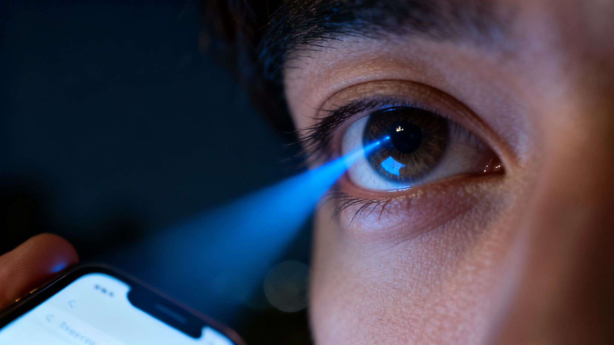 A close-up of a digital screen showing pixels, with a blueish glow emanating from it.