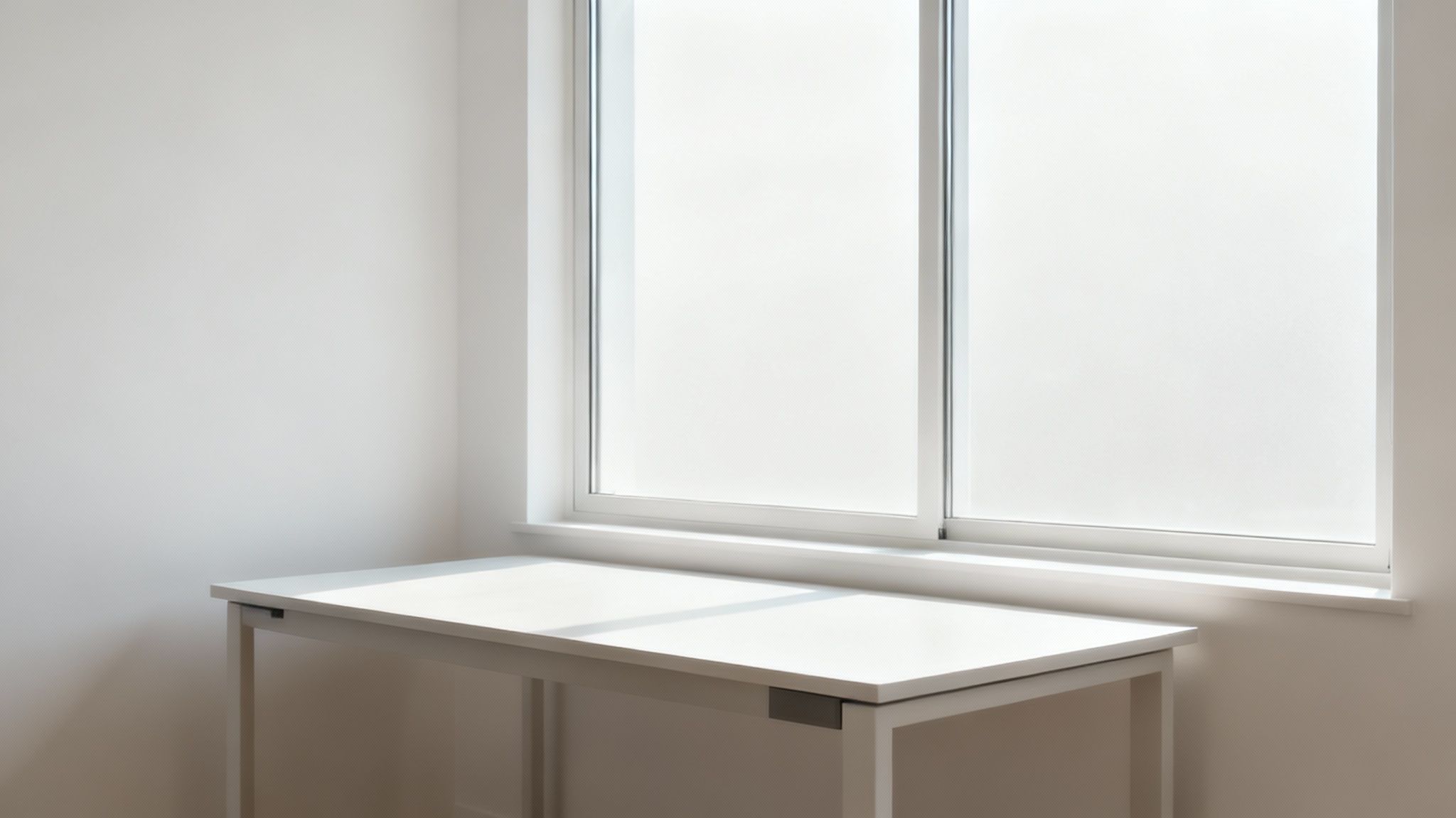 Person working on a computer in a well-lit room with natural light from the side.