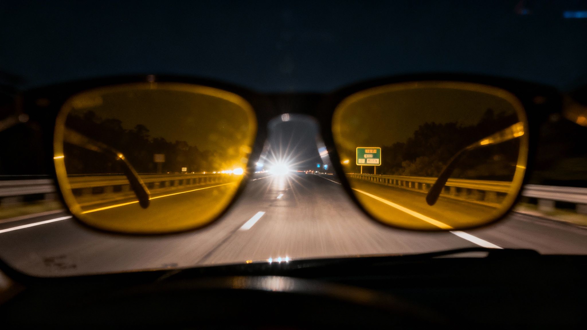 Driver's perspective at night showing the glare from oncoming headlights