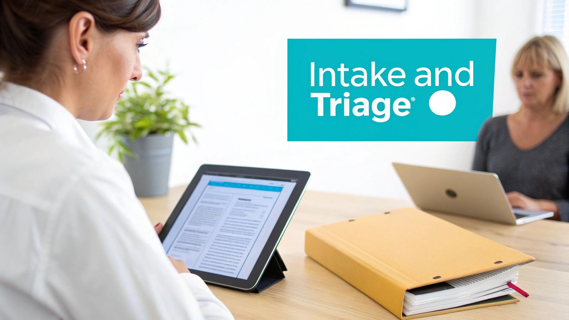 Two women process patient information using a tablet and laptop in a modern clinic with an 'Intake and Triage' sign.