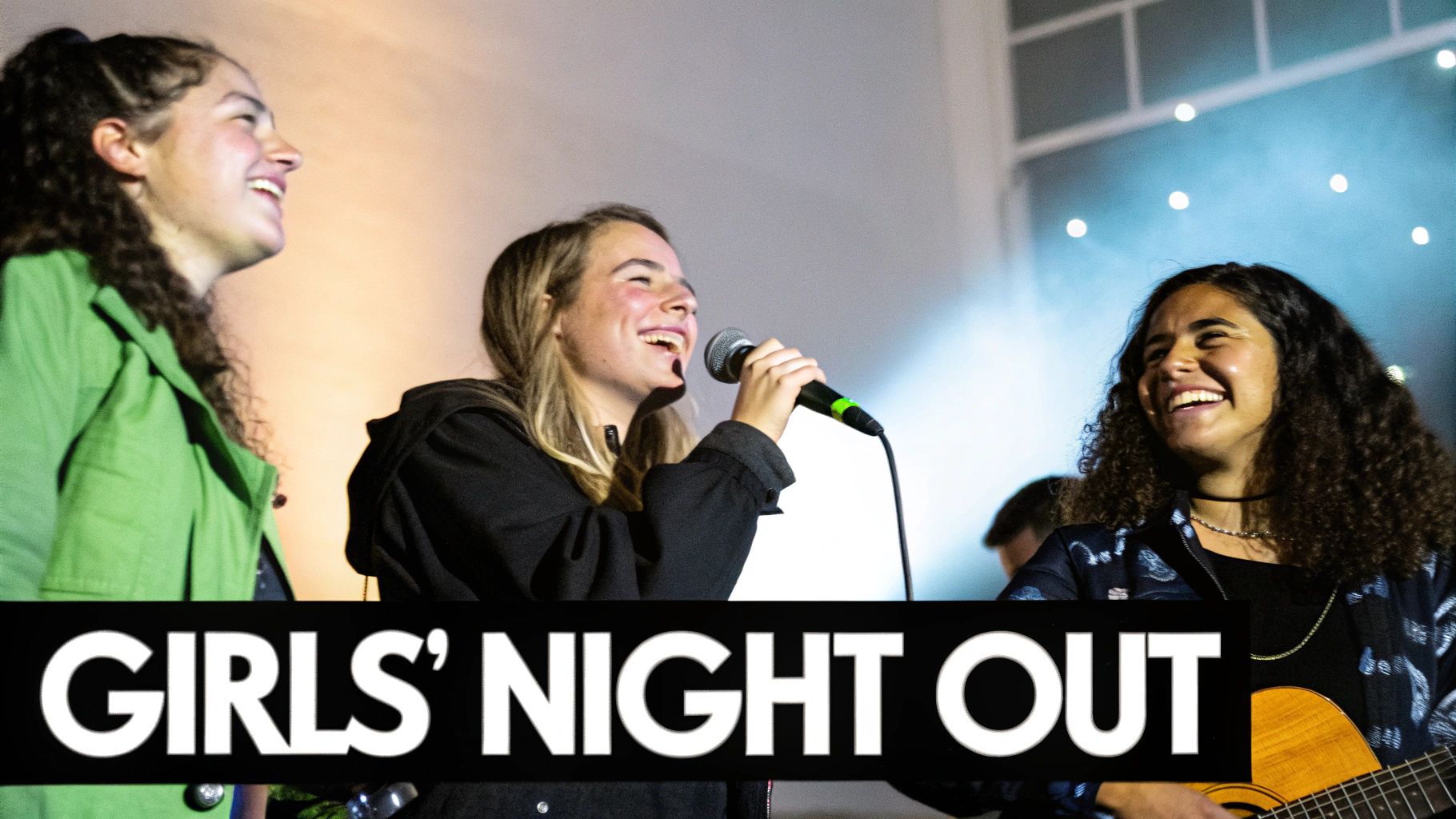 Joyful young women singing and playing guitar at a lively "Girls' Night Out" event.