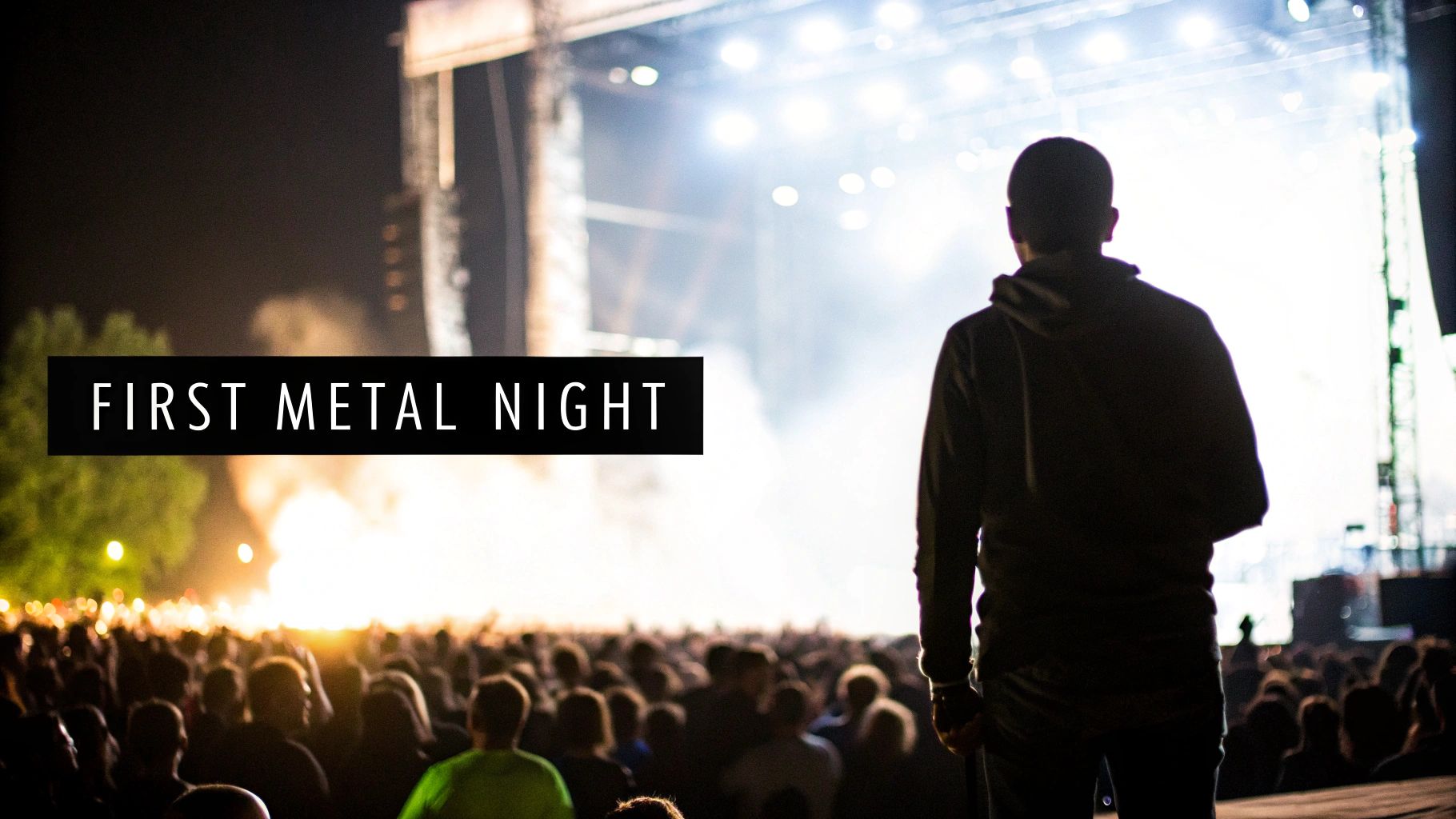 A person from behind watching a bright stage at a lively outdoor heavy metal concert at night.