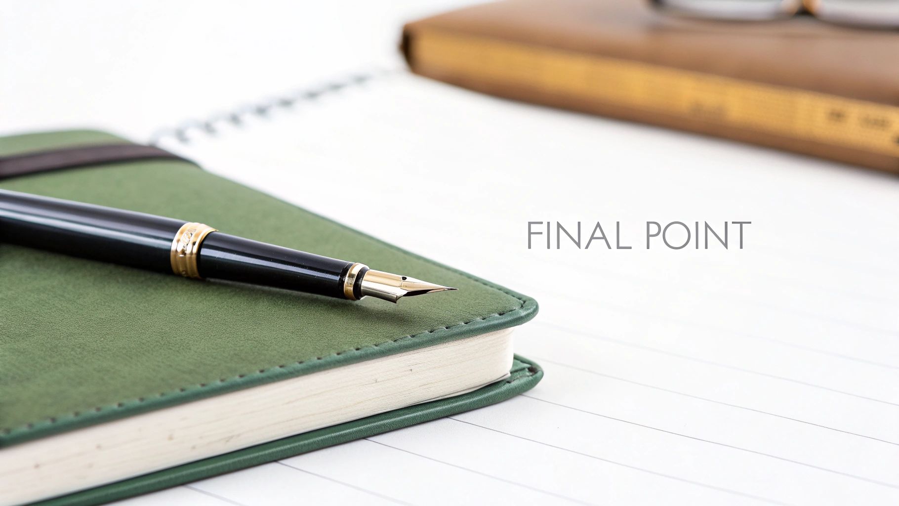 An elegant black and gold fountain pen rests on a green leather notebook with 'FINAL POINT' text on white paper.